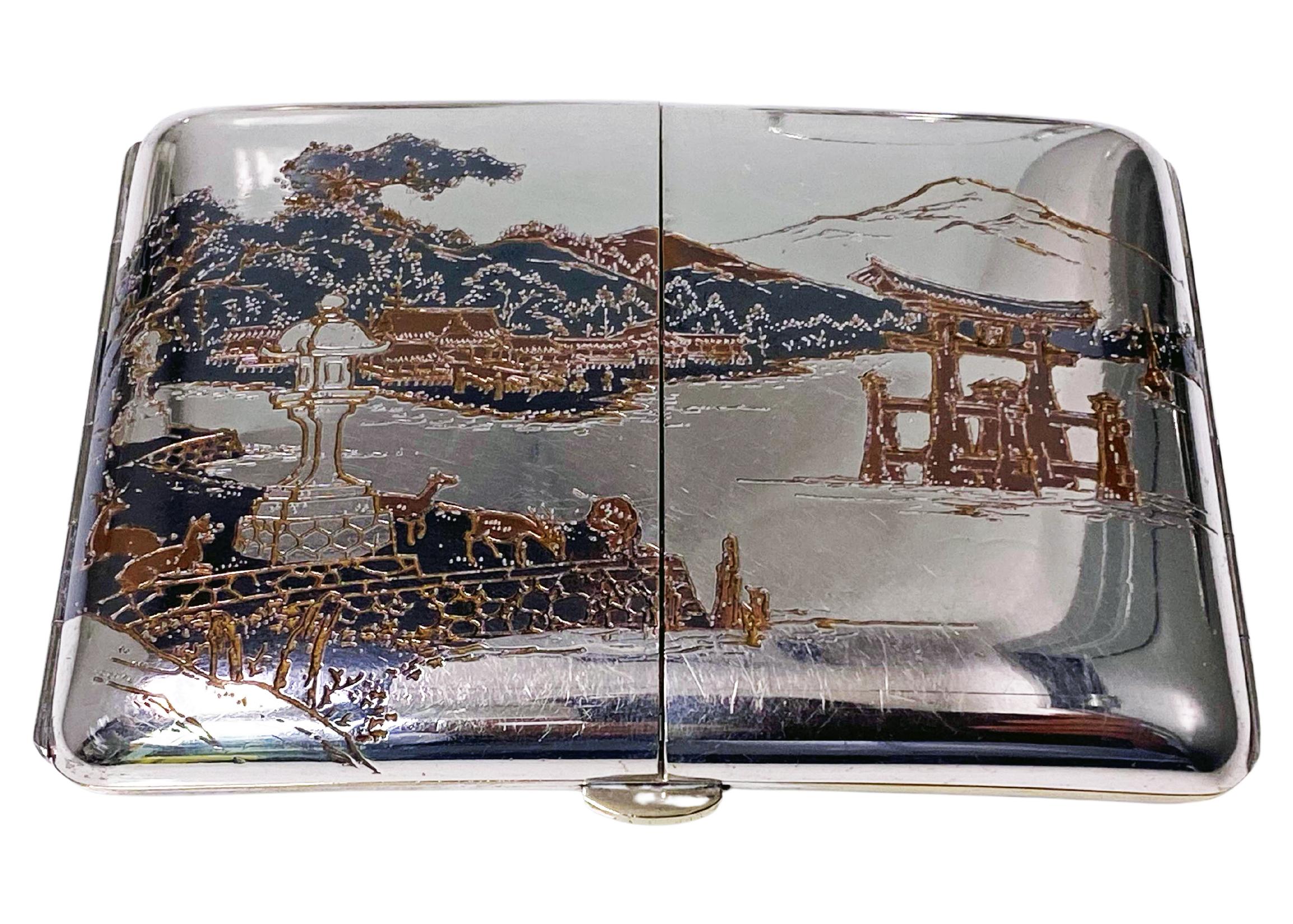 Japanese Sterling and mixed metals unusual three sectional cigarette case, C. 1920. Opens from the center to reveal stunning mixed metal scenes of Mountains (Mount Misen), Pagodas, Itsukushima Shrine and Otorii Gate, the Seto Inland Sea, Boats,