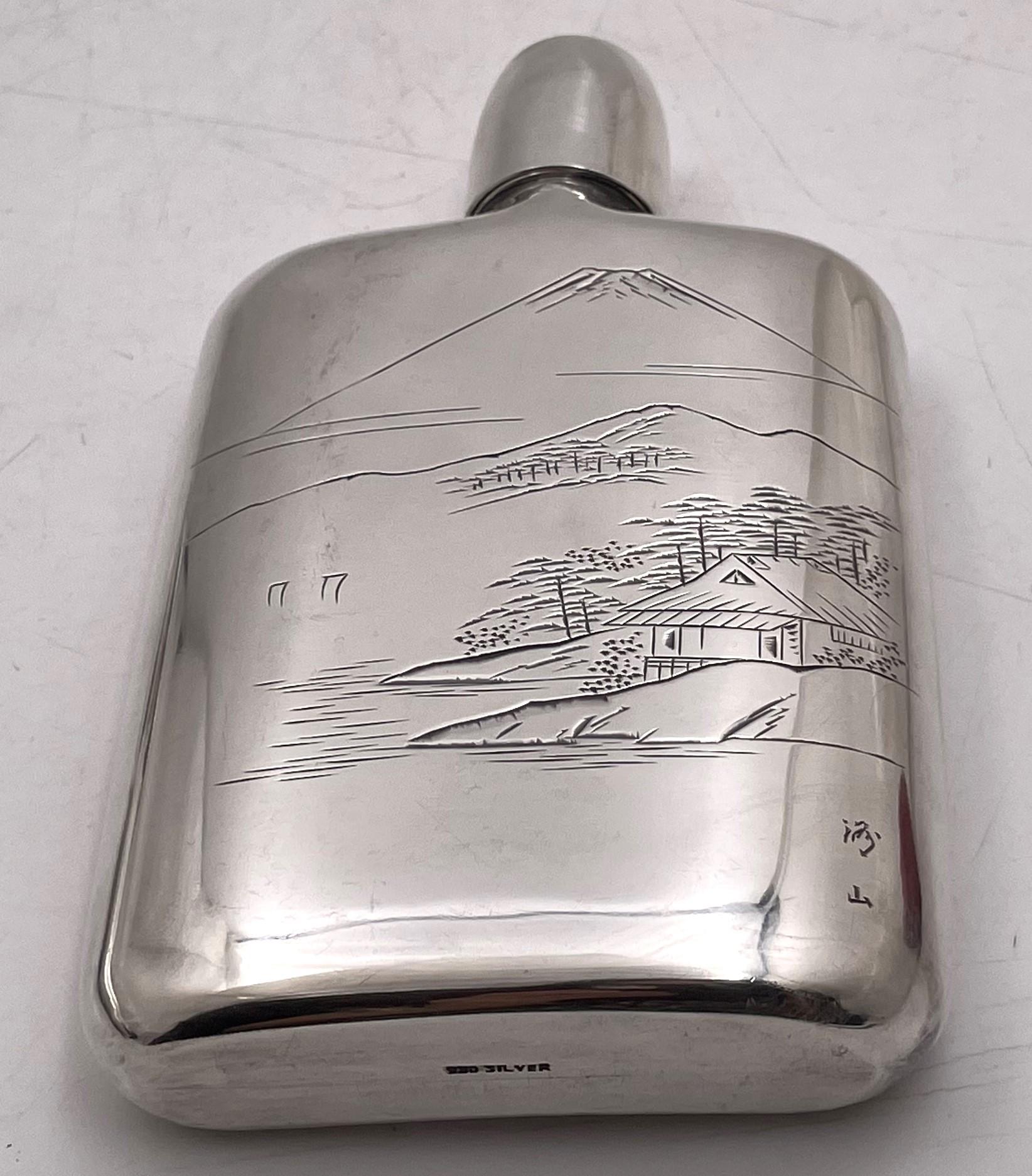 Japanese, 0.950 (higher purity than sterling) silver flask, finely engraved with a Japanese landscape on one side and hand-hammered on the other side, with an integrated shot glass, as shown. It measures 5 7/8'' in height by 3 1/4'' in width by