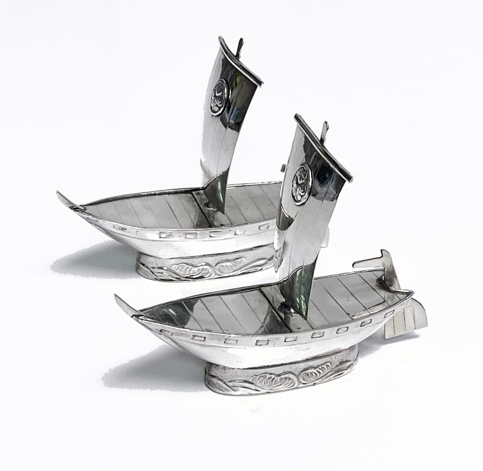 Unusual Japanese sterling silver salt and pepper in the form of sailing ships C.1950. Boat design salt and pepper cellars cauldrons each marked sterling and 950 to base. Pierced with three larger holes for Pepper and five smaller holes for Salt.
