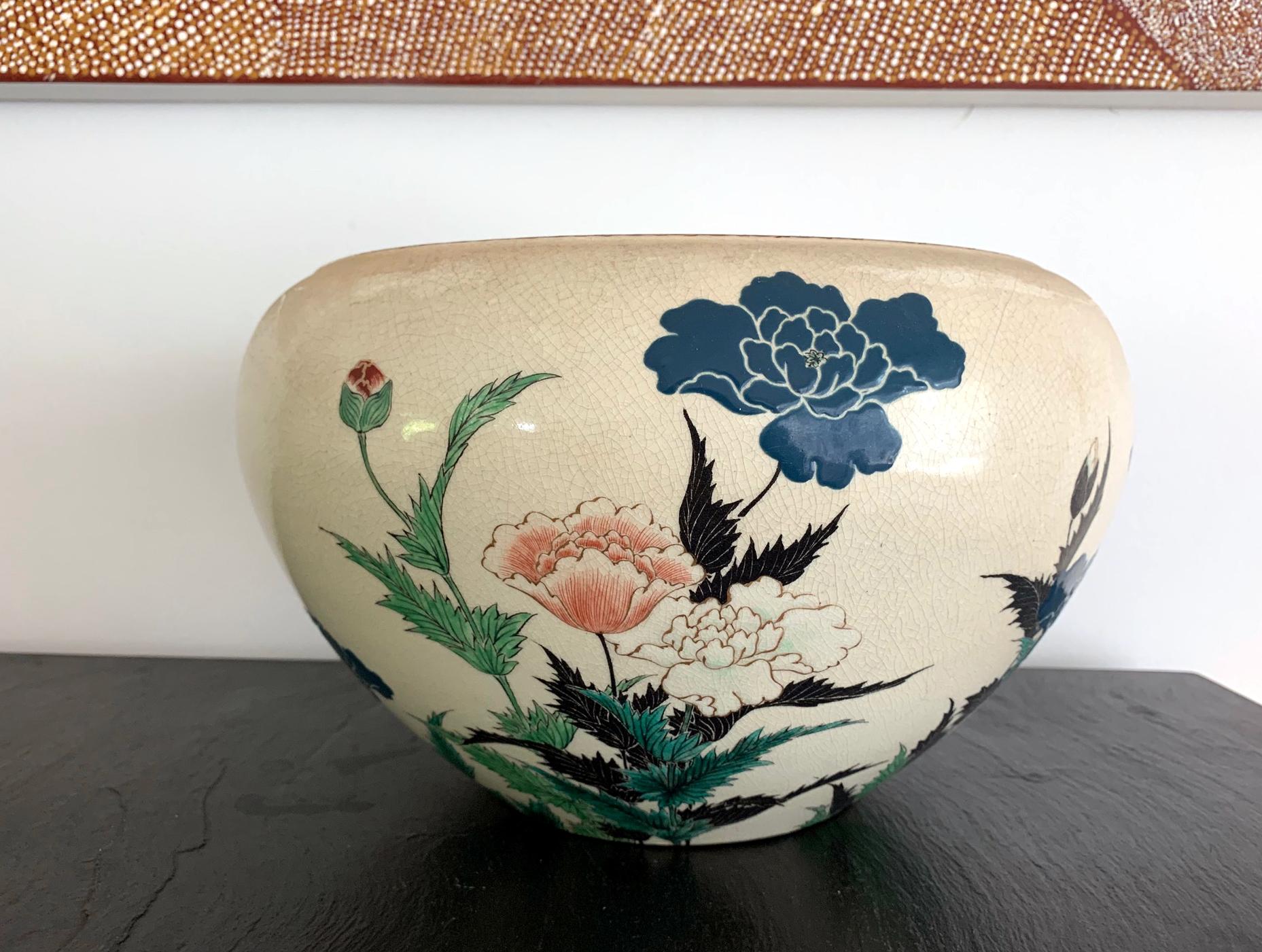 A beautifully crafted large ceramic bowl as a centerpiece by Okumura Shozan (1842-1905) in the Kyo-yaki (kyoto ware) style. A Classic ovoid form with flatly inverted rim of swirled scroll pattern, the piece was decorated with naturalistic floral
