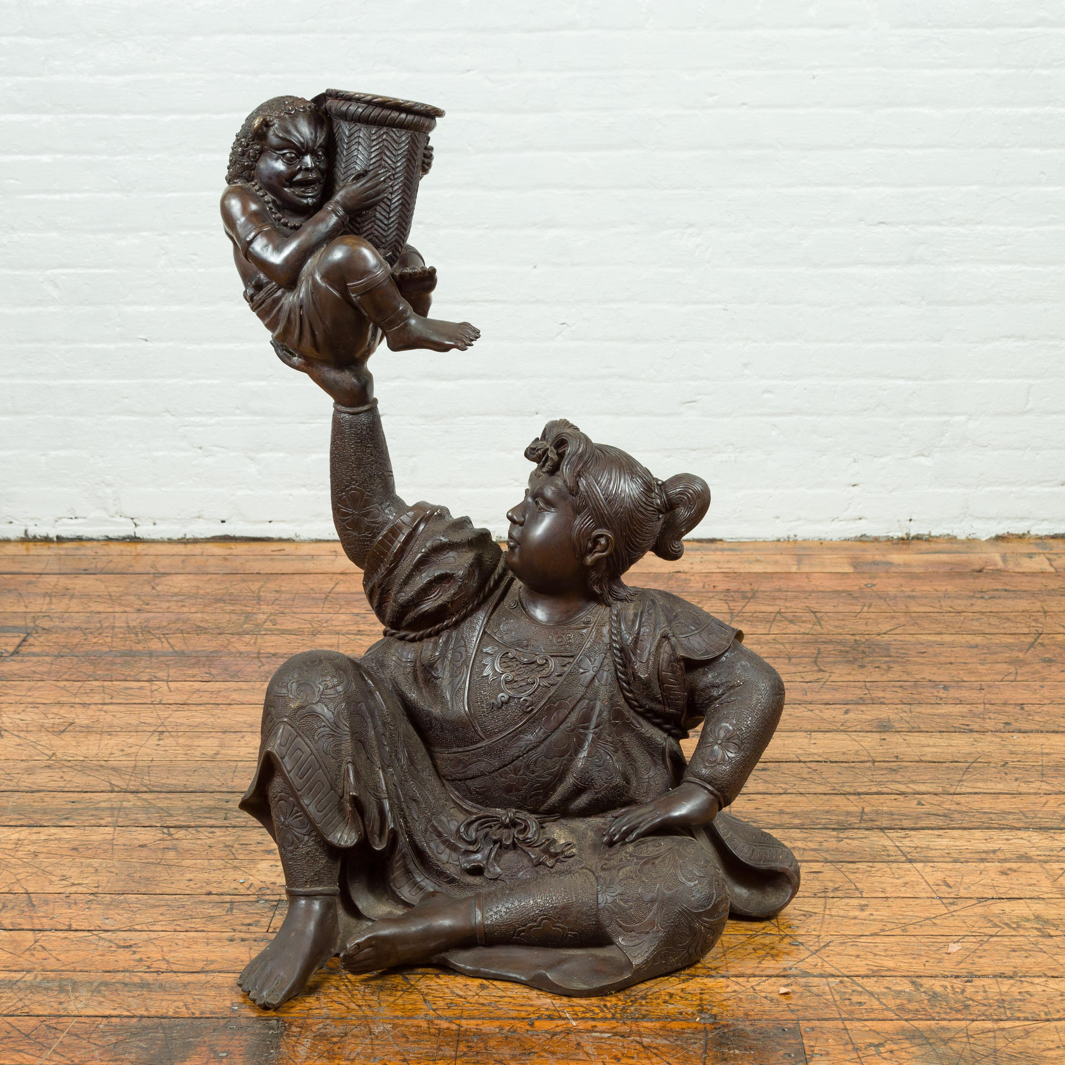 A Japanese style bronze sculpture from the 20th century, depicting a woman holding a mythical creature with rattan basket. Created with the traditional technique of the lost-wax (à la cire perdue) that allows a great precision and finesse in the