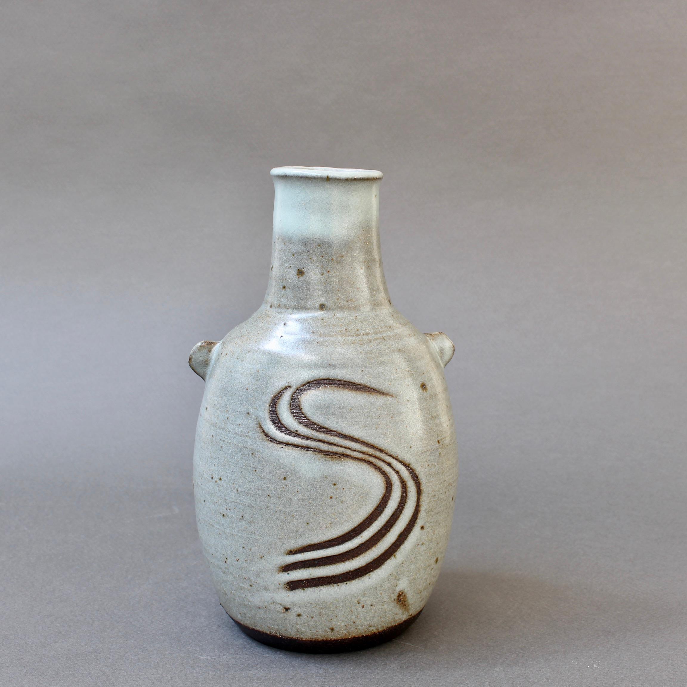 Vintage Japanese-style ceramic vase with lugs by Janet Leach (1981). Encompasses the beautiful simplicity of Zen and translated to a piece of pottery. The S on the ash-glaze body of the piece is reminiscent of a rake mark in a Zen garden not unlike