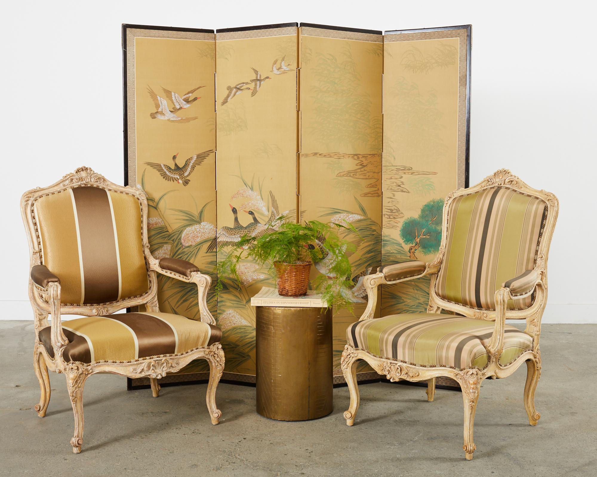 Tall Japanese style four panel byobu screen that is probably Korean. The screen was constructed in the Showa period and depicts a flock of geese flying over flowering reeds. Ink and natural color pigments over a gold toned ground. The painting is