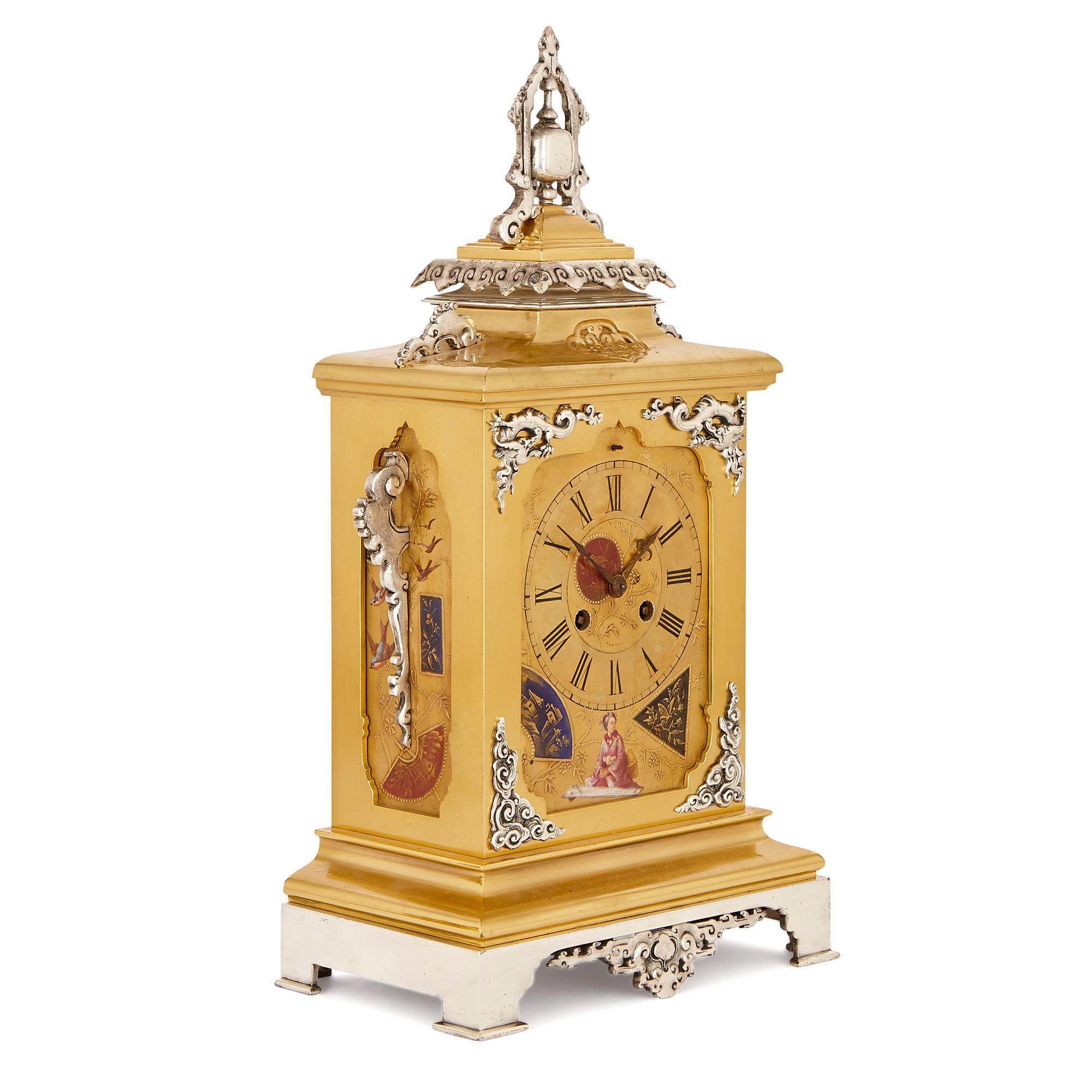 This Japanese style clock set was crafted in France in circa 1880. The set consists of a central clock, which is accompanied by two vases. 

The central clock features a gilt brass rectangular body with a pitched top, like a pavilion roof. The