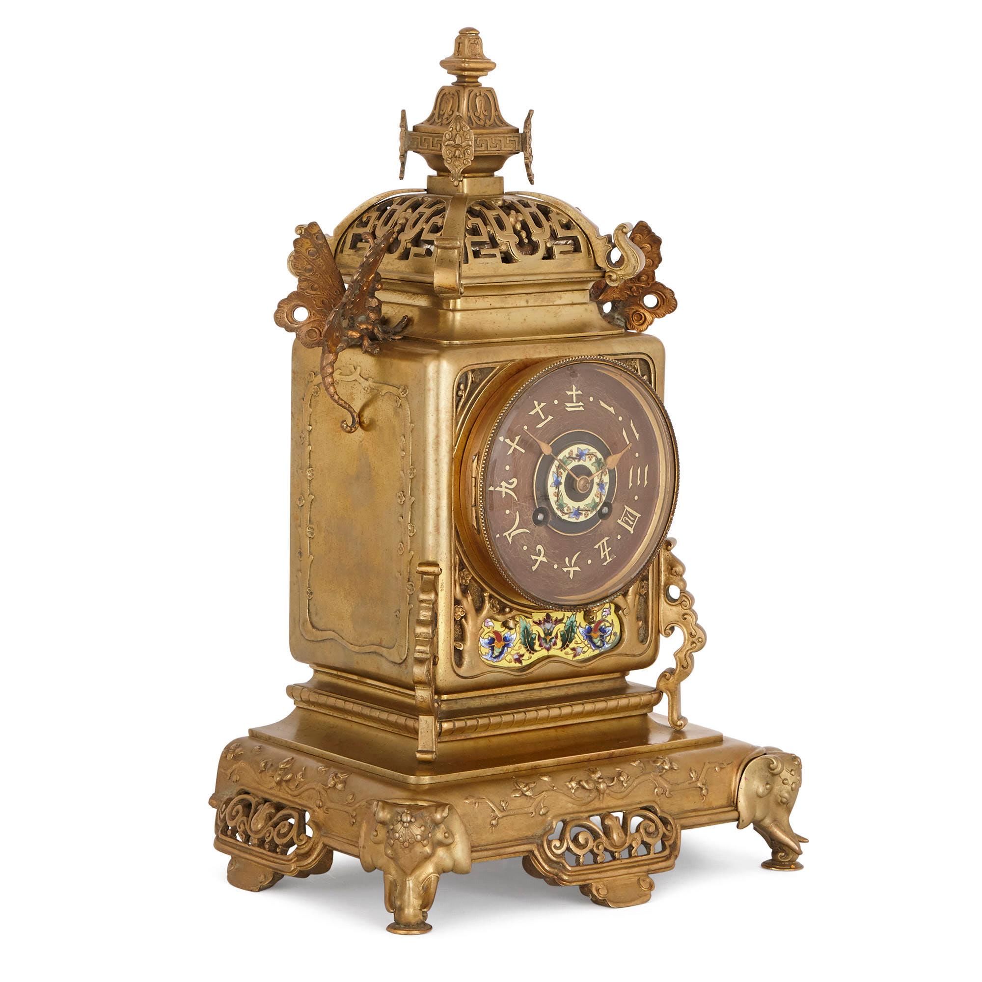 This beautiful clock set is designed in a fanciful Japanese style, known in France in the 19th Century as ‘Japonisme’. The style became highly fashionable in Europe after 1853, when Japan reopened to trade with the West. Japanese goods—including