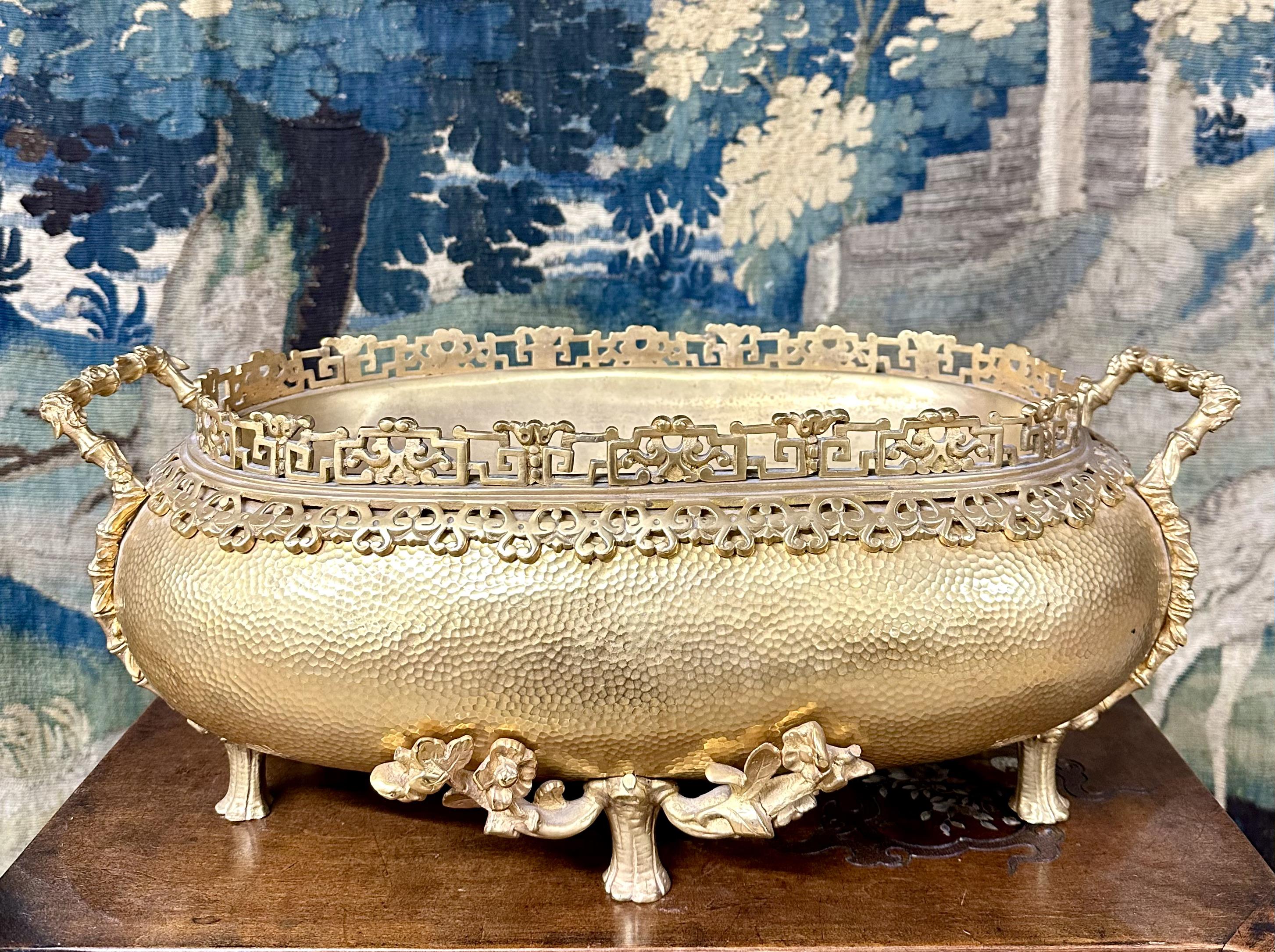 Large gilt bronze planter with Japanese decor composed of a frieze at the neck, the handles and the base with vegetal decor. The basin is in hammered bronze and has a stamp of the Compagnie des bronzes de Bruxelles under the base. Very good state.