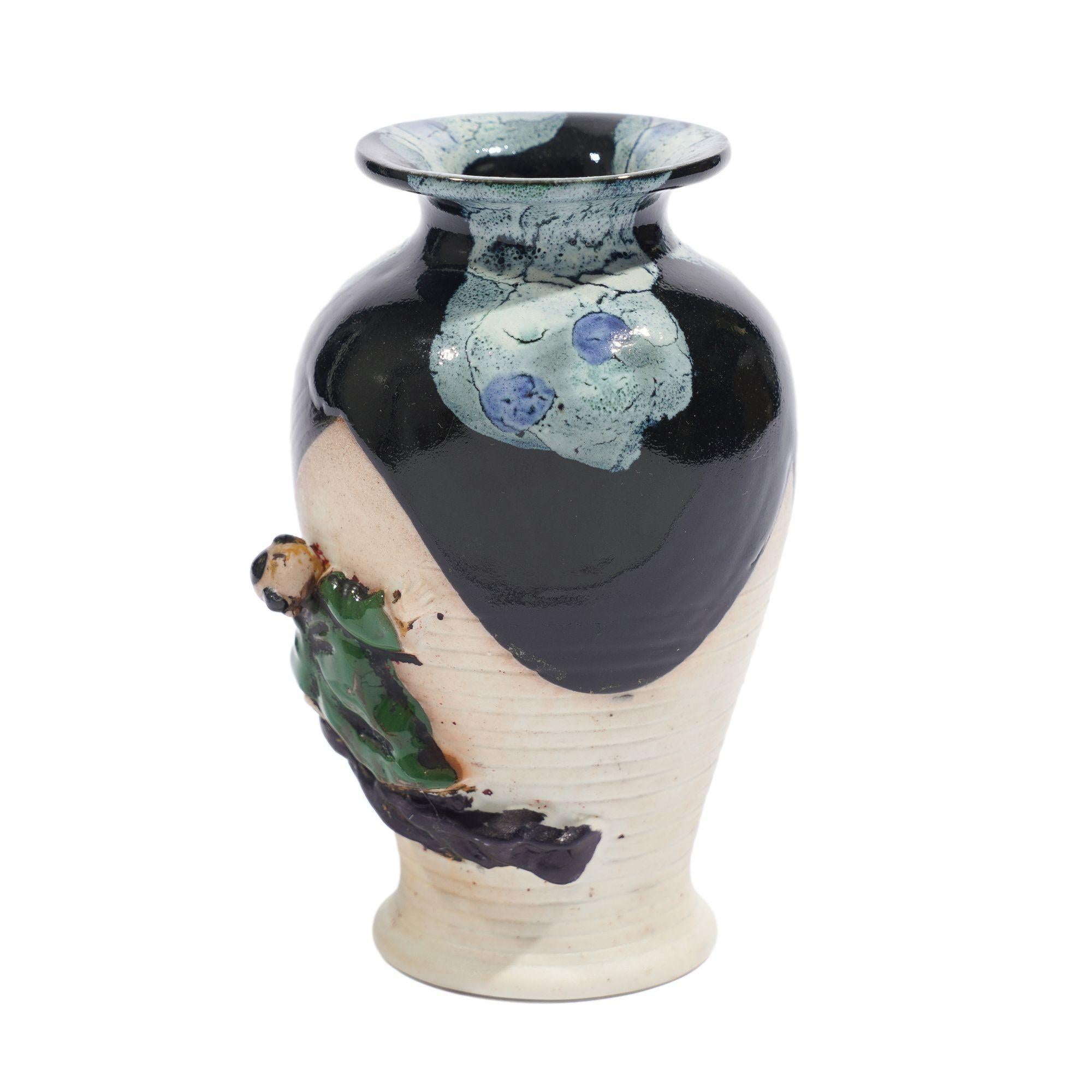 Sumida Gawa hand thrown baluster form vase with partial glazing and an applied figure of a small child climbing the side of the vase.

Japan, made for the Western trade, circa 1890.
