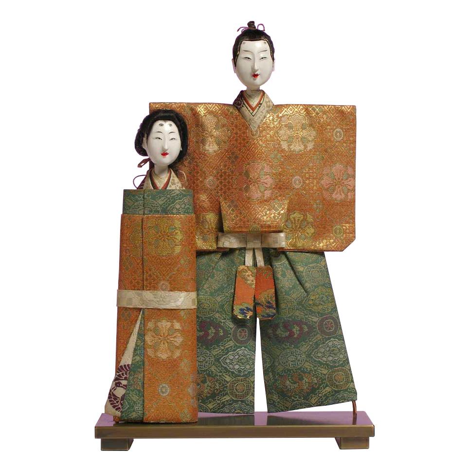 Japanese Tachibina, the simple essential form of the imperial couple used as the display for the girl’s day celebration, constructed of kinran brocade fabric covered paper, the heads carved of wood and covered in go fun with painted features and