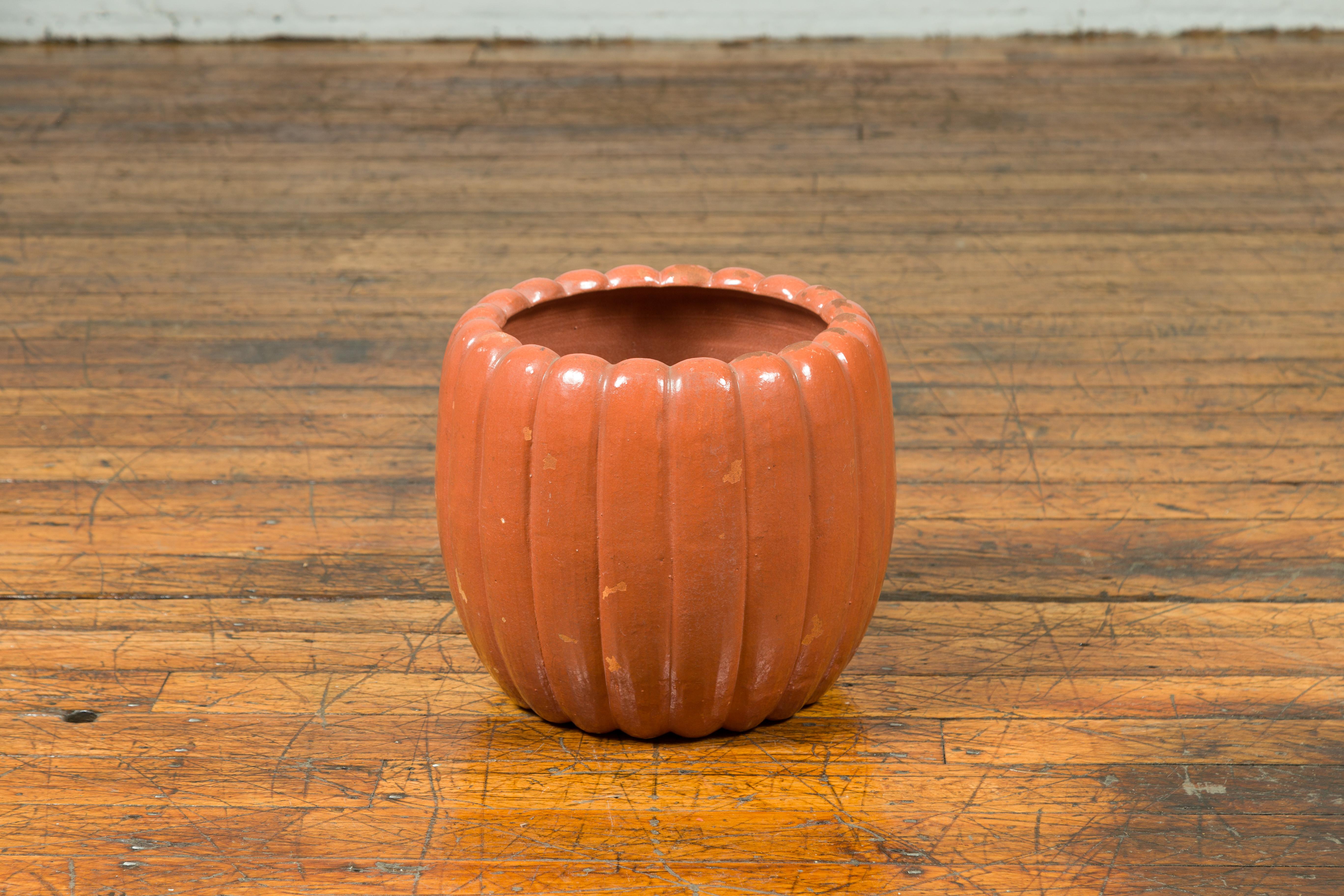 A Japanese Taisho period handmade pumpkin-shaped planter from the early 20th century, with distressed marks. Crafted in Japan during the Taisho period (circa 1912-1926), this whimsical planter features a coral pumpkin gadrooned shape, showcasing