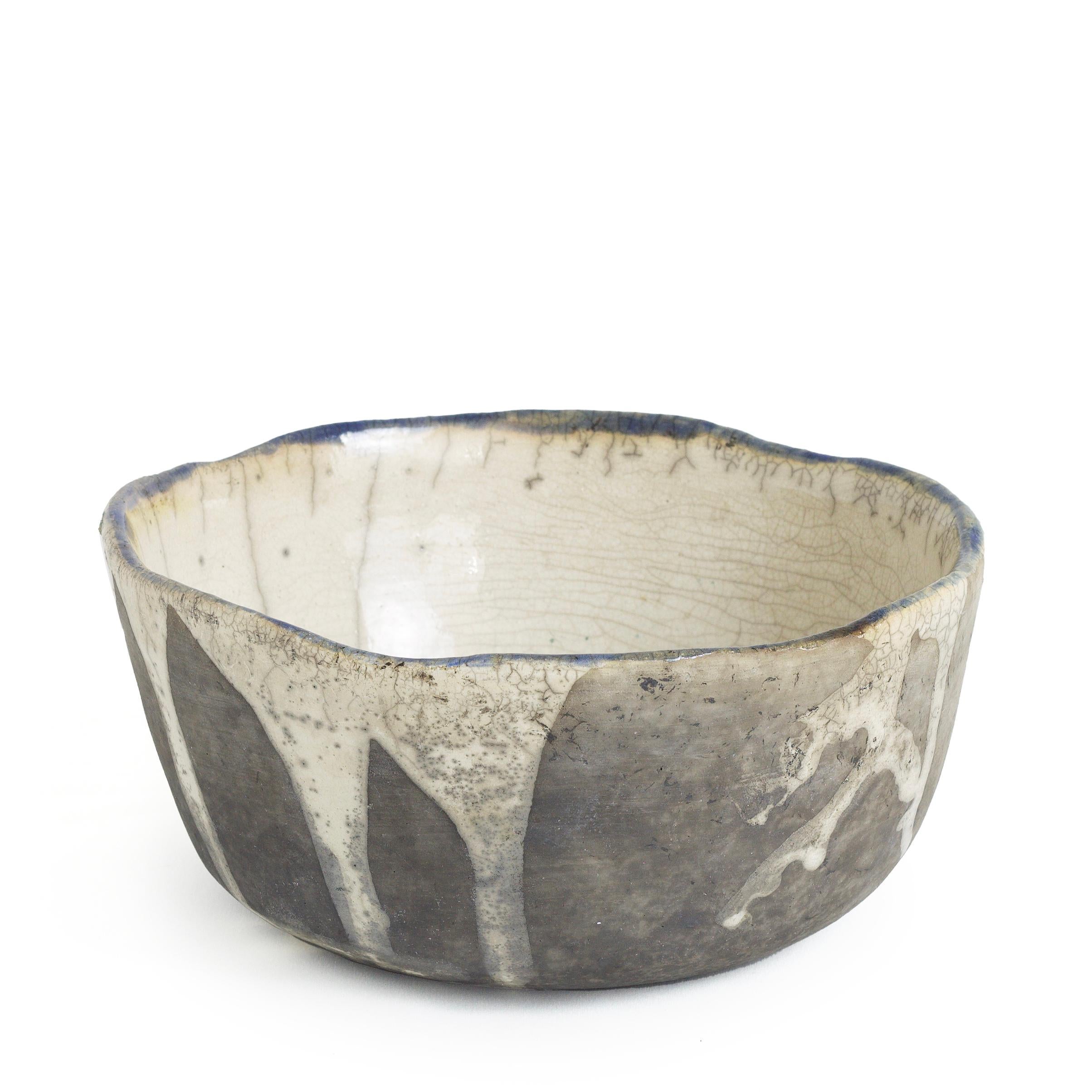 Tanoa is a large bowl, designed with simplicity and masterful skill of the raku firing technique expressing the master artisan will in its white crackle drippings and black burn clay effect. A large, natural, organic looking piece that can be a