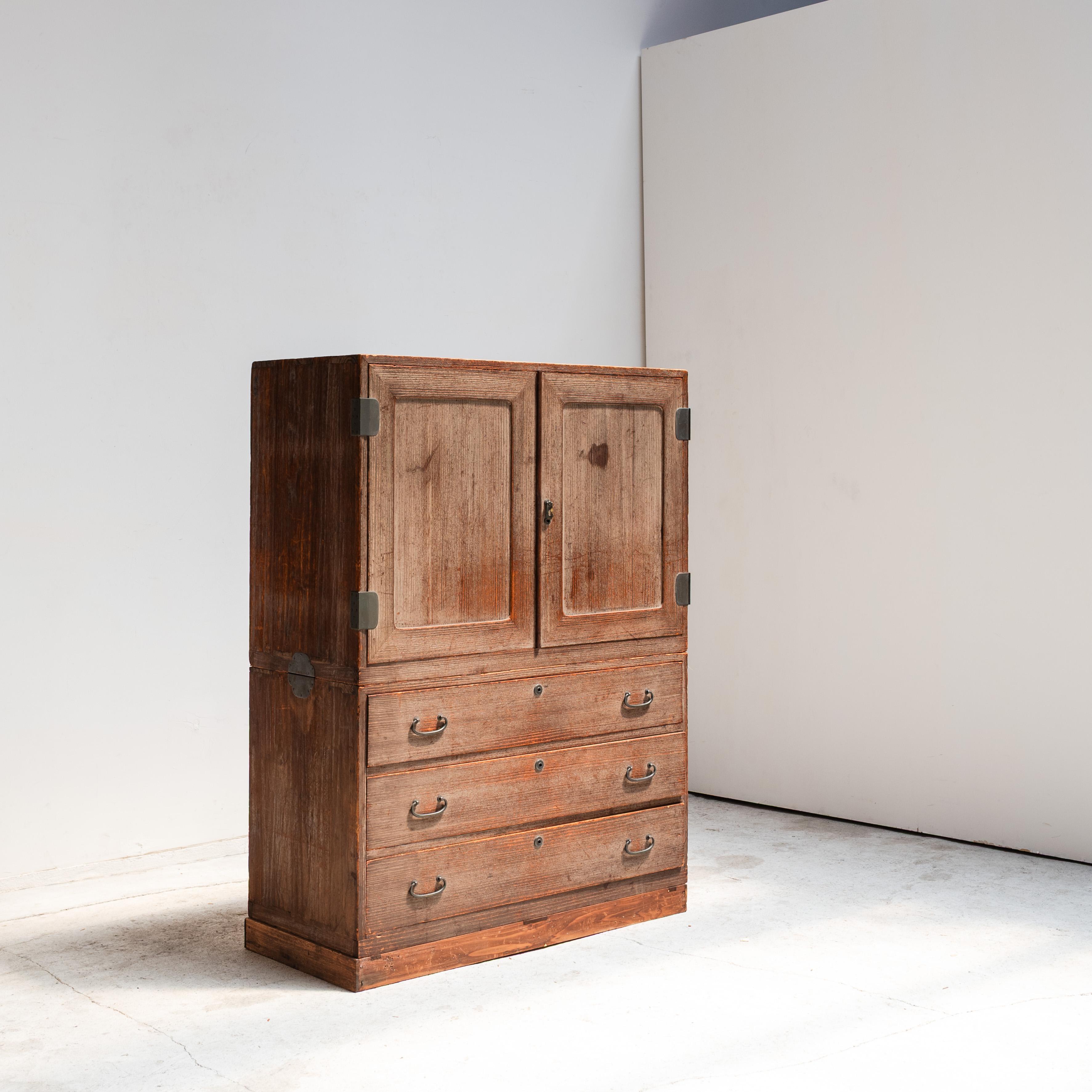 A finely crafted Japanese tansu chest, composed of three separate stacking elements: a base plinth, a section of drawers, and a top cabinet with hinged doors concealing sliding trays. This modular construction not only reflects traditional Japanese