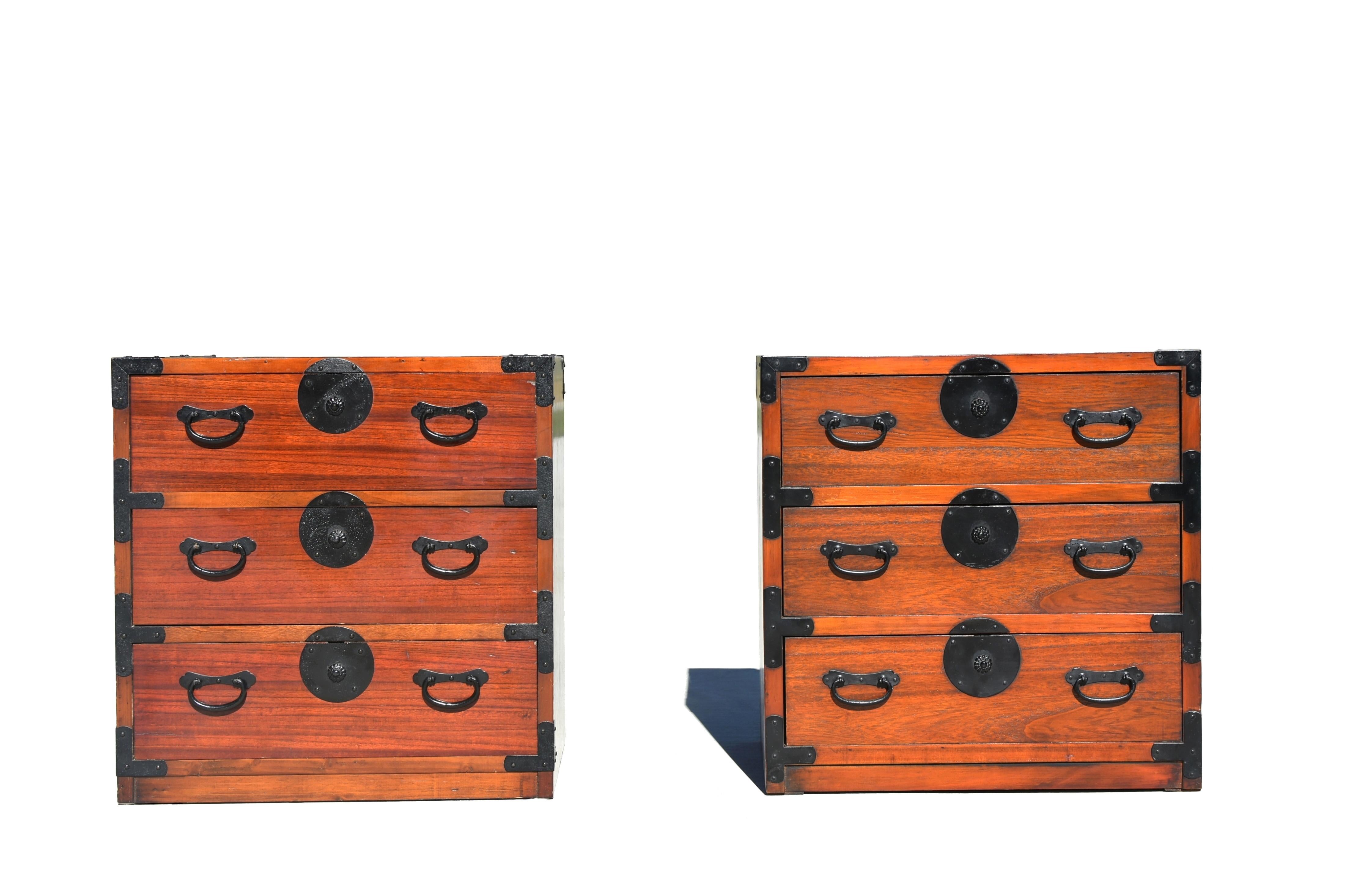 A set of two vintage Japanese tansu chests. The two chests are identical except one has a slightly darker, more reddish finish. This is a way for Japanese craftsmen to demonstrate custom pieces made with choice wood, as clear finish allows the color