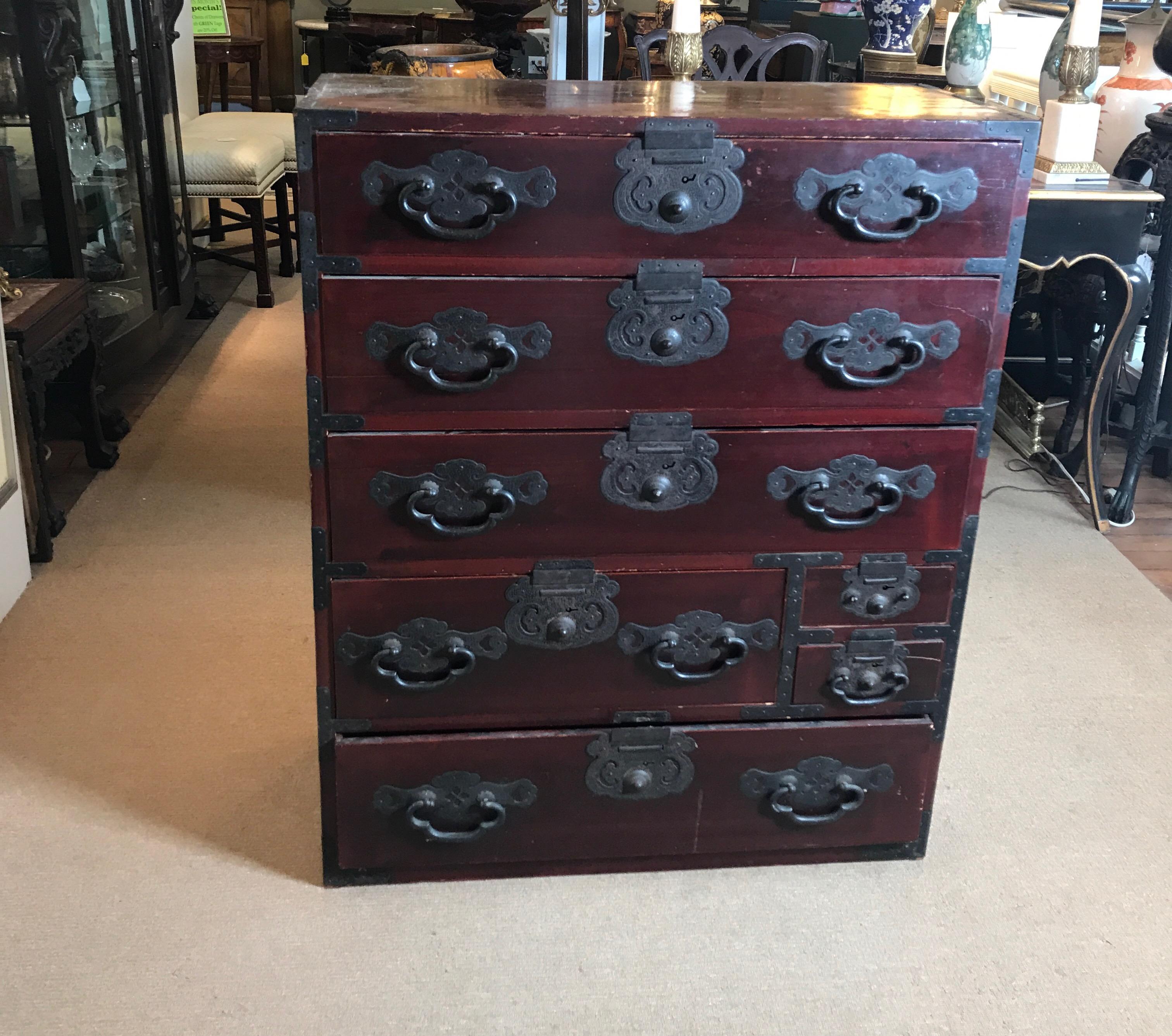 Original antique lacquered Tansu chest with iron hardware. The handmade hardware of very high quality attached to a hardwood chest with original worn lacquer. The piece is in original unaltered condition showing shrinkage of the boards with
