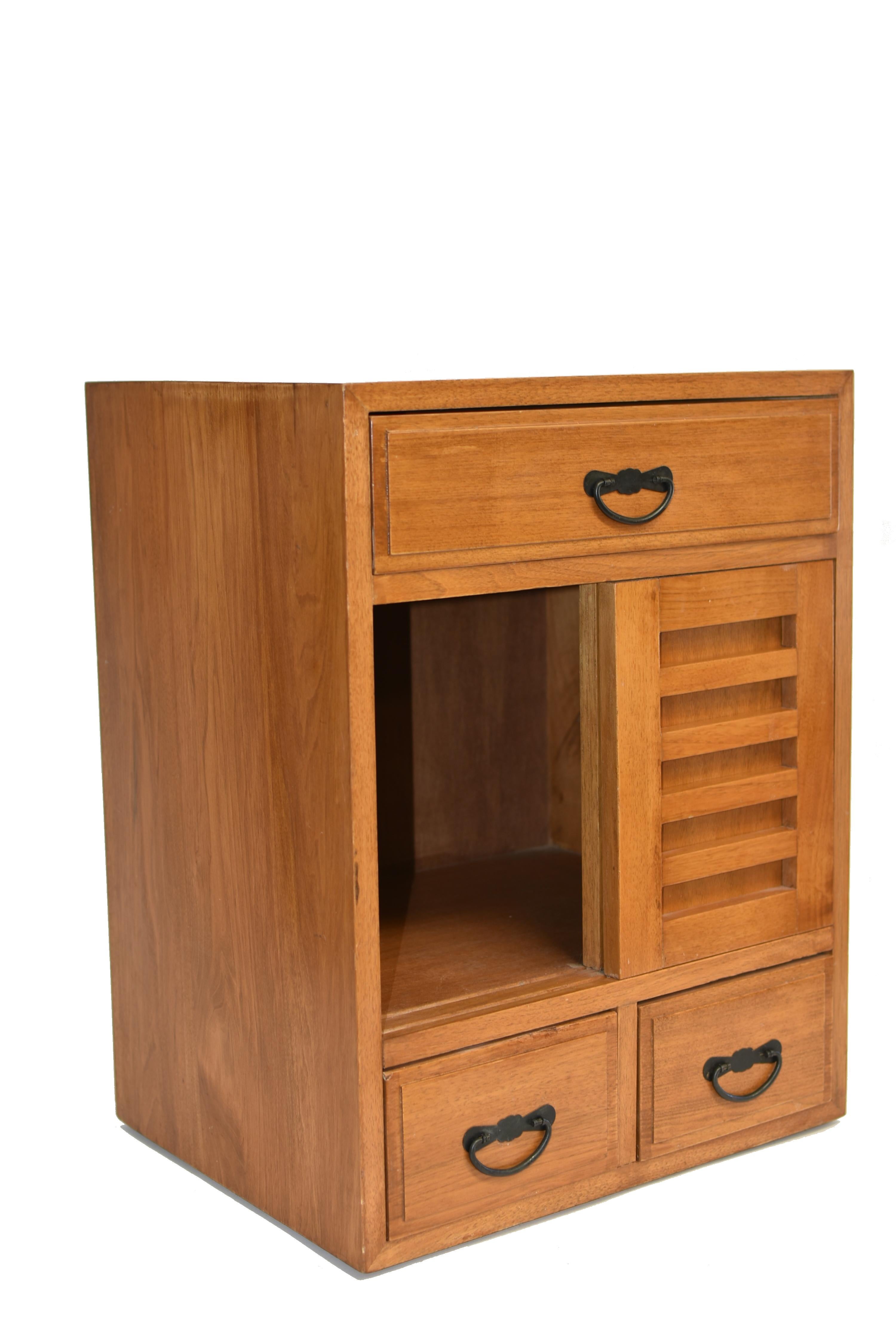 A small vintage solid wood Japanese tansu with 3 full depth drawers and sliding doors. Beautiful, choice woods, solid construction. Doors slide smoothly to conceal a large storage space. A functional, versatile piece for your home and office. In