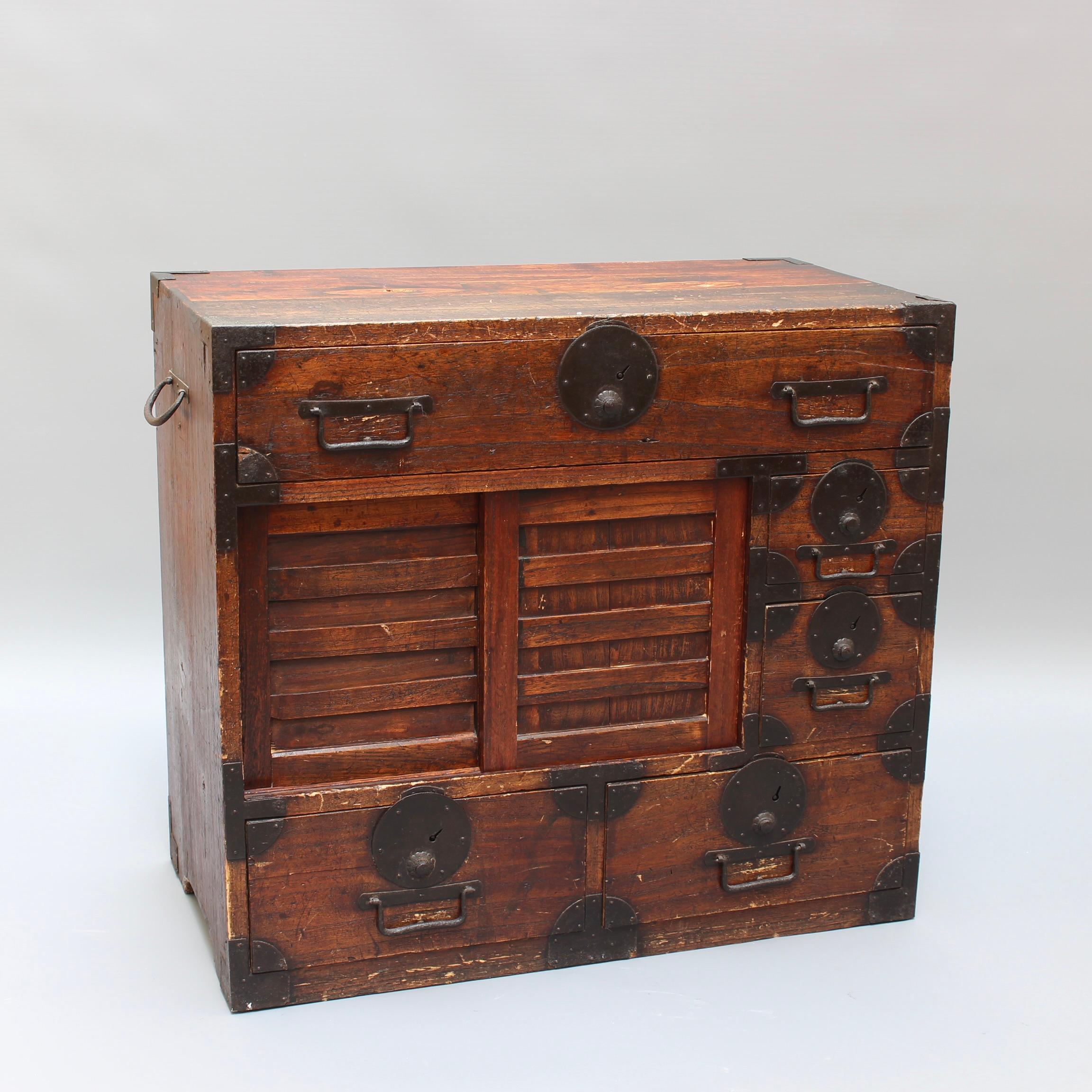 Japanese Tansu Storage Chest (Edo Period - 19th Century). Tansu are traditional portable wooden storage chests from Japan. In Japanese traditional houses, there were no fixed chairs, tables, or pieces of furniture in the living space. Tansu were