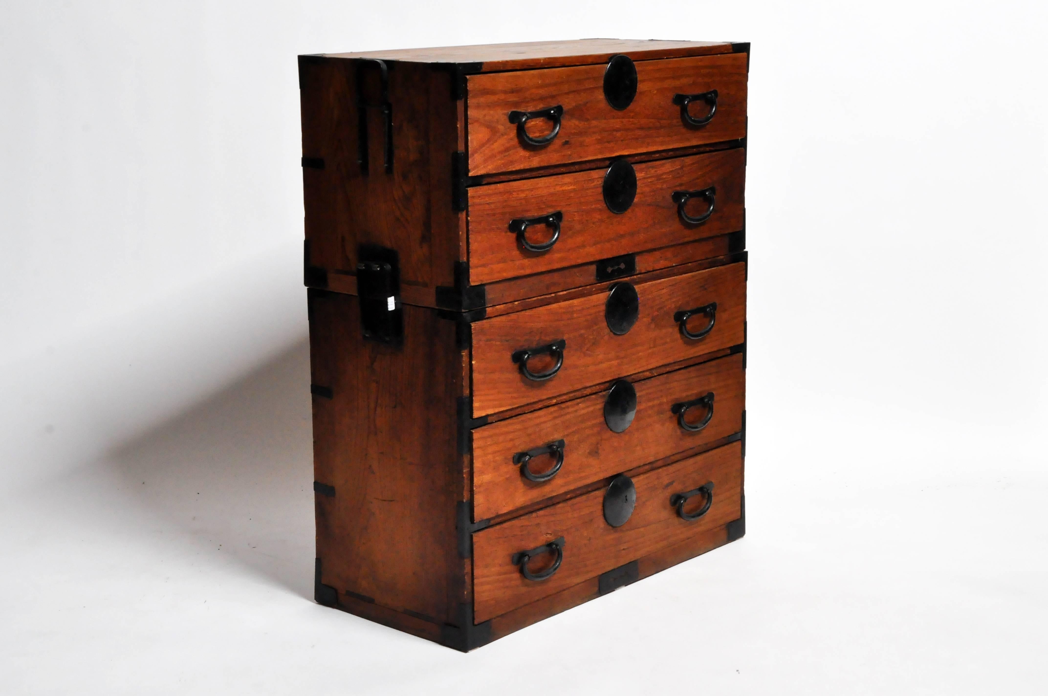 This two part Tansu chest is from Japan and was made from paulownia wood, circa 1900. The piece features five drawers and can either be stacked on top on one another or separated and used as a nightstand or side table.