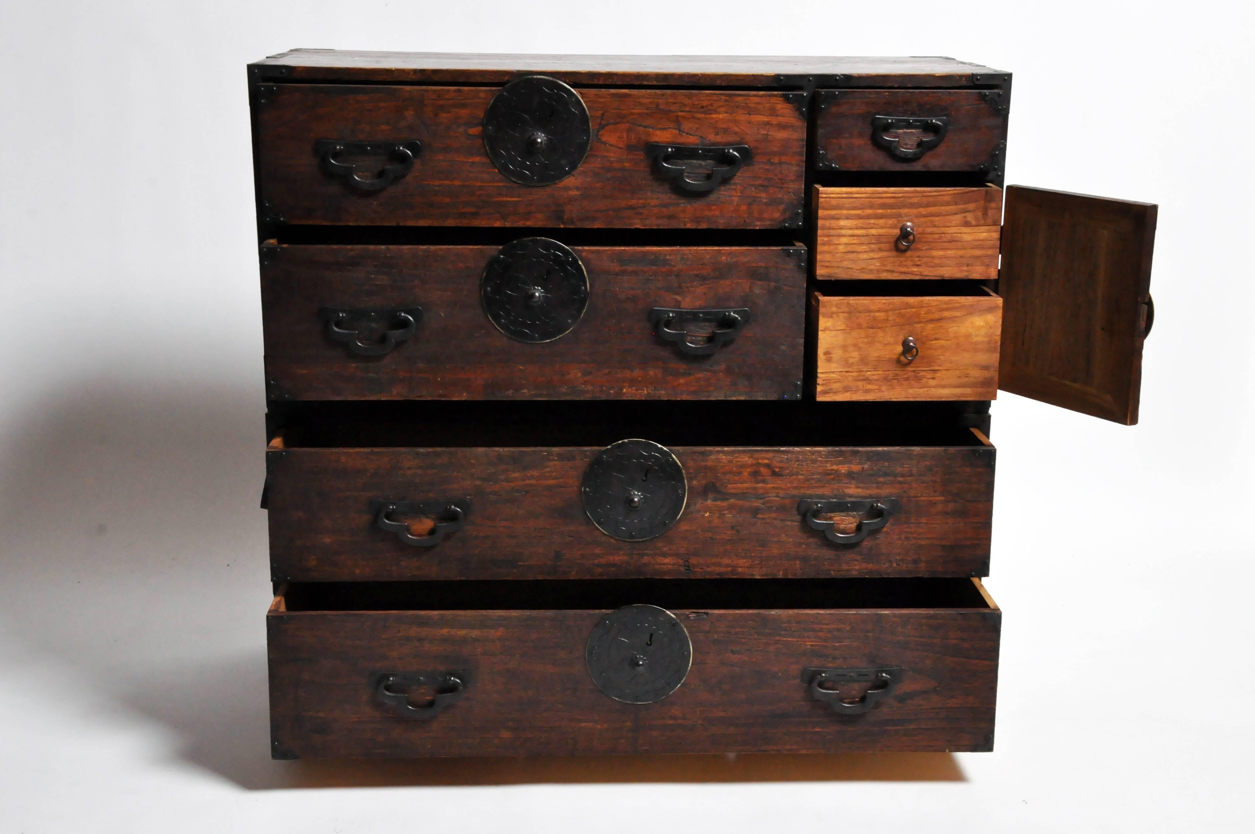 This two part Tansu chest is from Japan and was made from paulownia wood, circa 1900. The piece features seven drawers total and can either be stacked on top on one another or separated and used as a nightstand or side table.