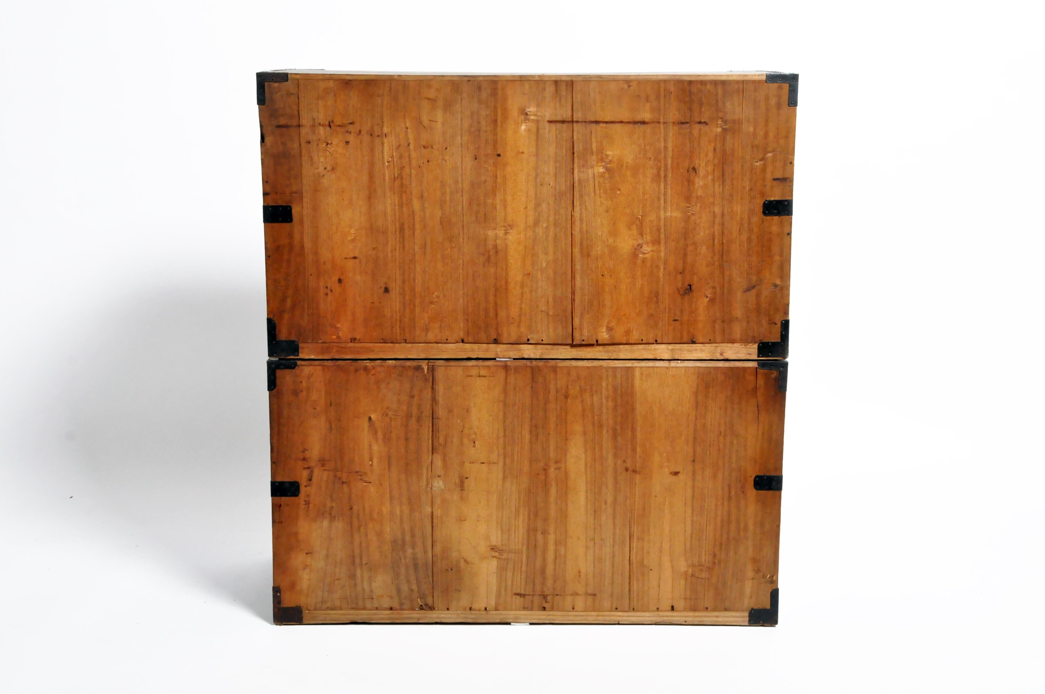 This two-part Tansu chest is from Japan and was made from pine wood, circa 1900. The piece features 4 drawers total and can either be stacked on top on one another or separated and used as a nightstand or side table. Wear consistent with age and use.