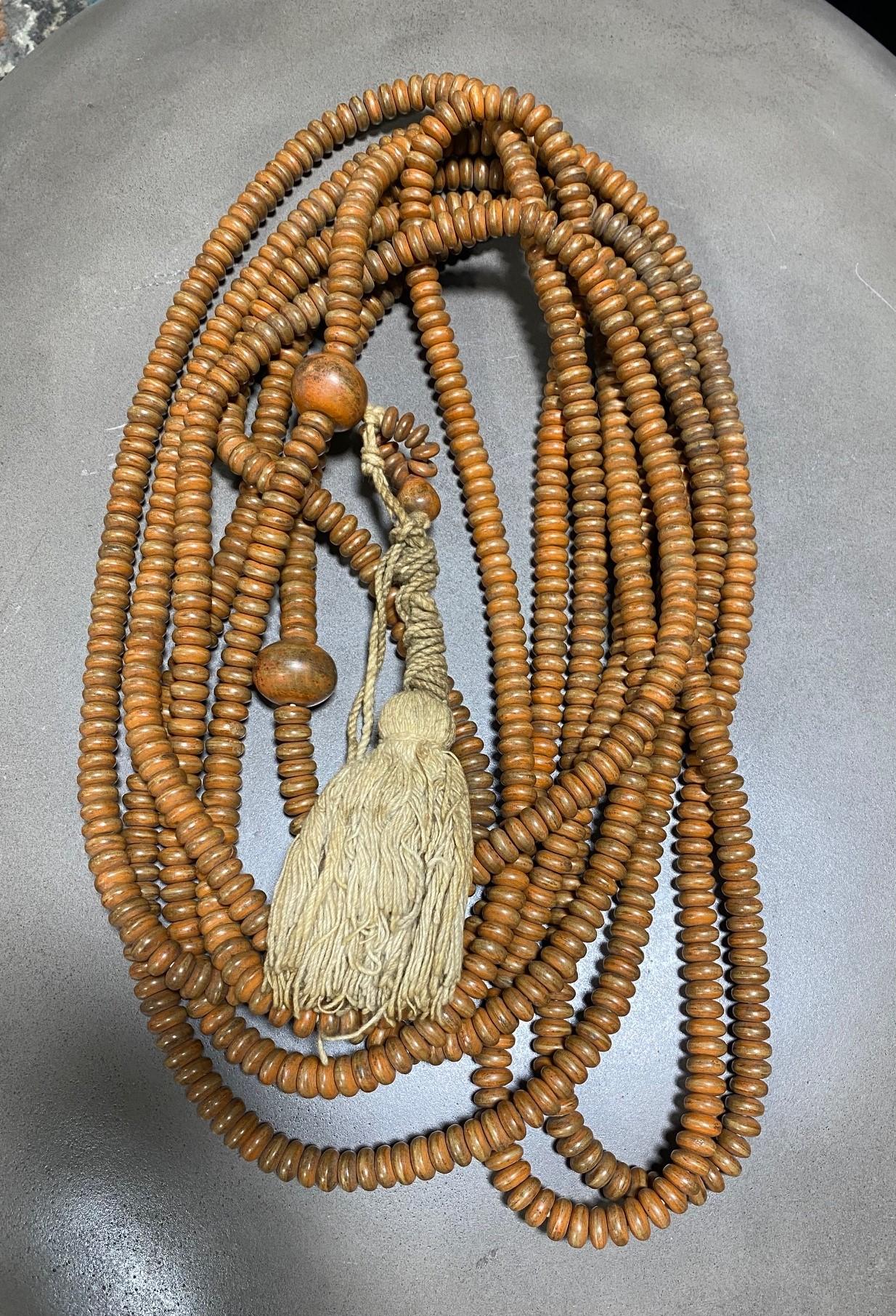A truly magnificent and special work - this nearly 20-foot long string of Japanese hand-crafted natural wooden (perhaps Rosewood) Buddhist Juzu mala beads with customary larger 