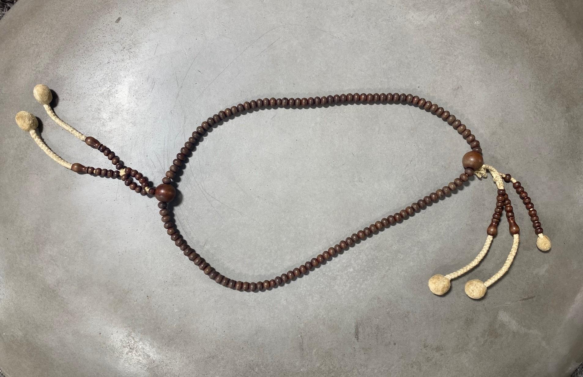 A beautiful string of Japanese hand-crafted Buddhist Juzu mala beads made of natural wood. These rosary-type prayer bead necklaces were used by Buddhist monks in temple prayers/rituals and worn by Samurai as amulets of protection. This type of Juzu