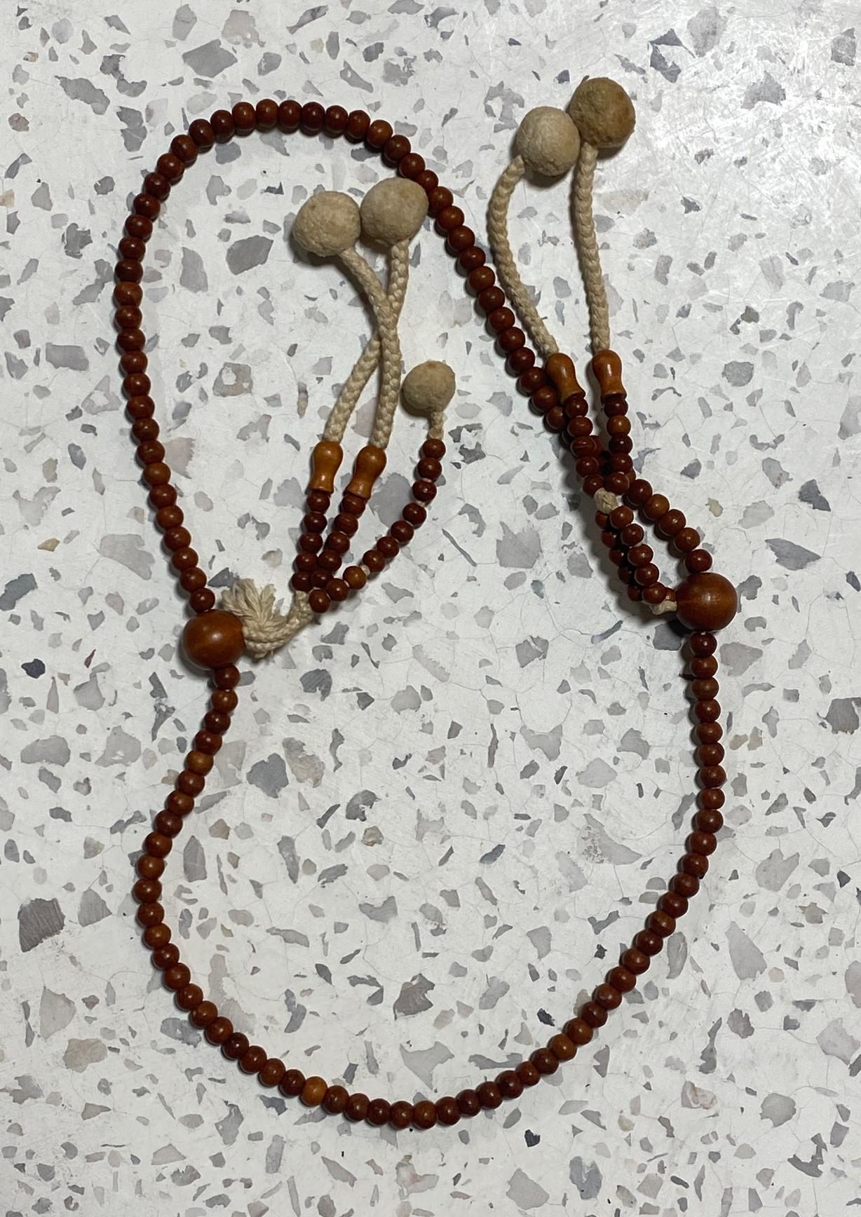 A beautiful string of Japanese hand-crafted Buddhist Juzu mala beads made of natural wood. These rosary-type prayer bead necklaces were used by Buddhist monks in temple prayers/rituals and worn by Samurai as amulets of protection.  This type of Juzu
