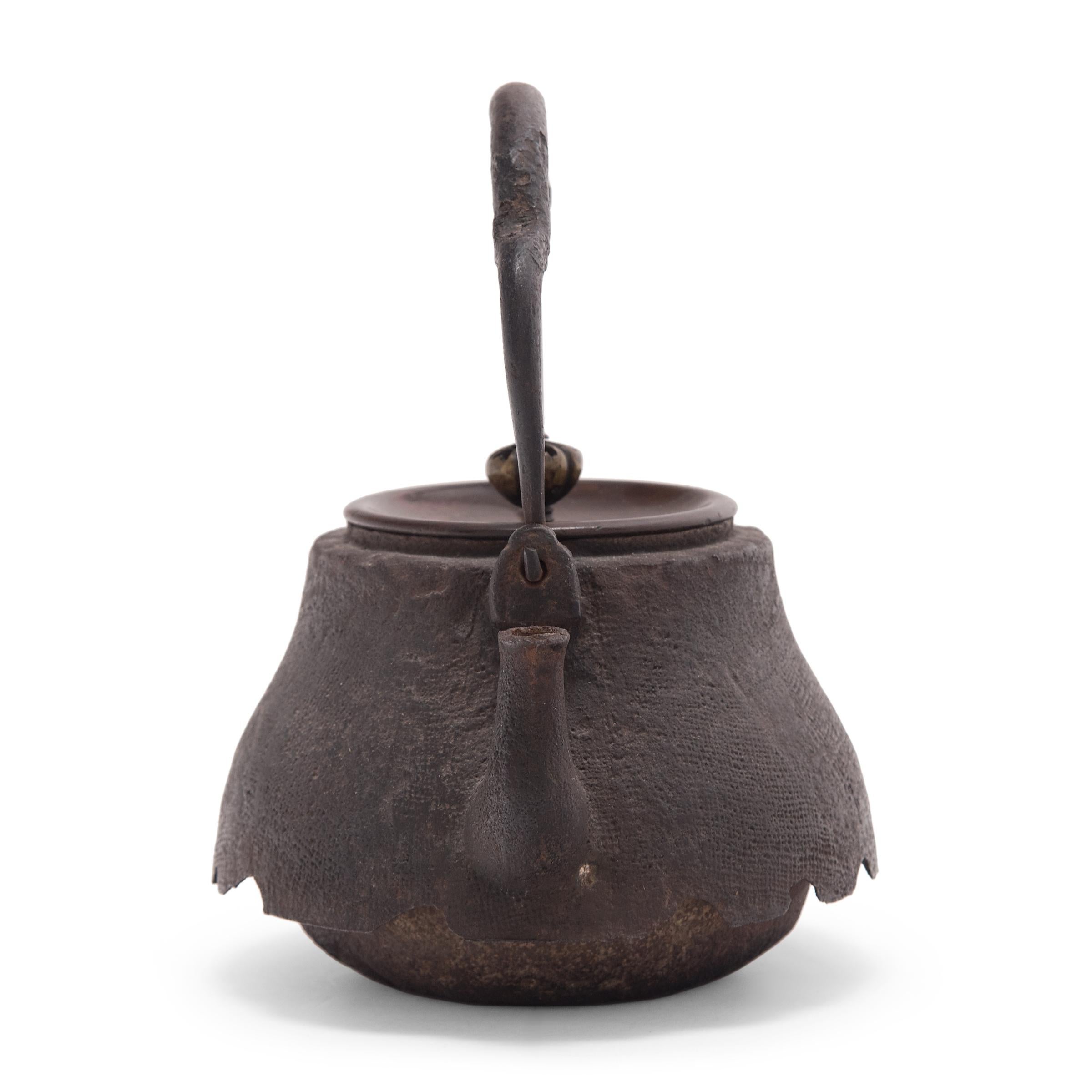 Decorated with an irregular, textured surface, this Japanese teapot was used to boil water for traditional tea ceremonies. Known as tetsubin, the kettle’s cast-iron construction is said to change the quality of the water, making tea taste mellow and