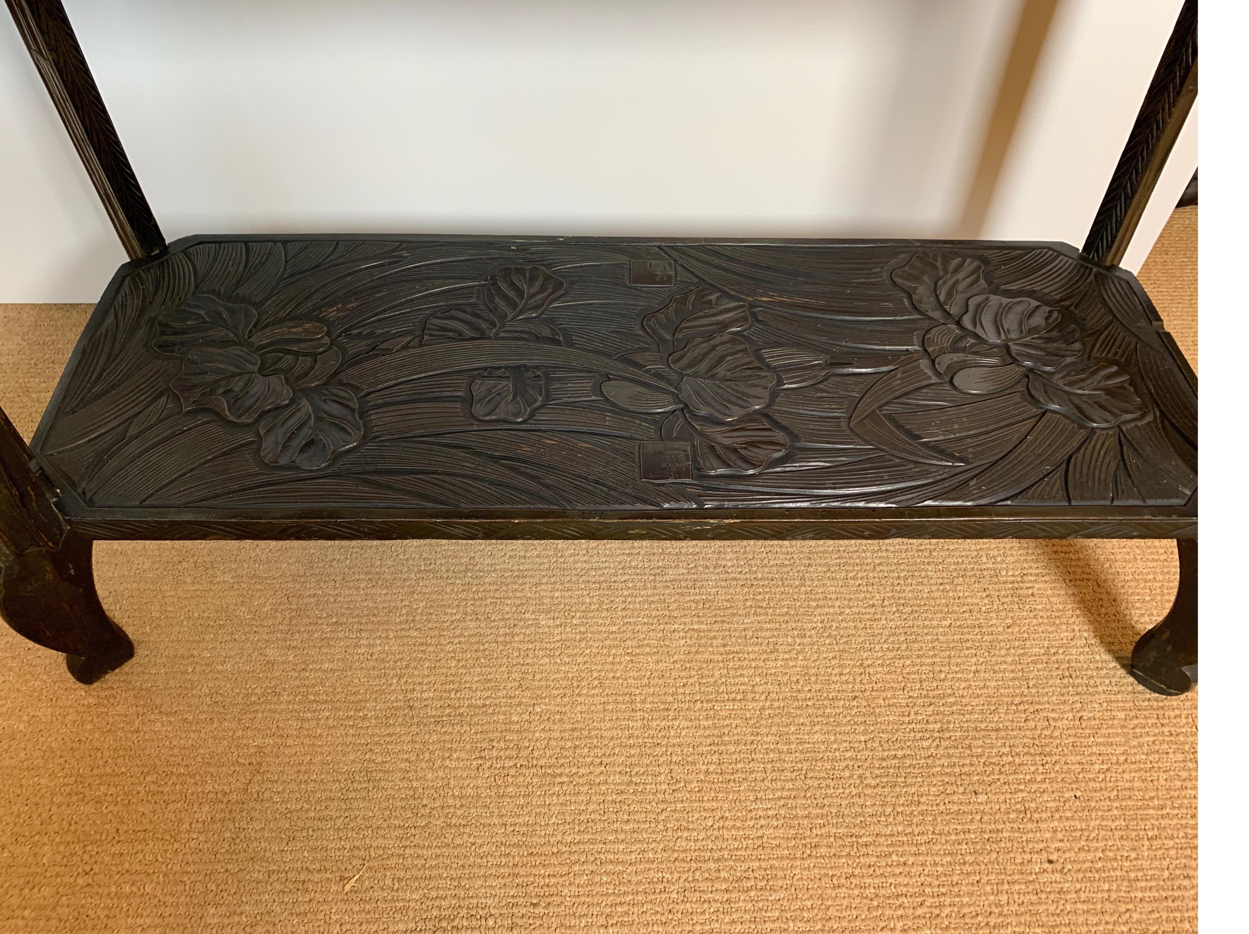 Exceptional Japanese botanical hand carved three tier shelf, circa 1905- Art Nouveau period. The dark finish is almost ebonized with slight wear to the original finish. Masterfully carved and well cared for.