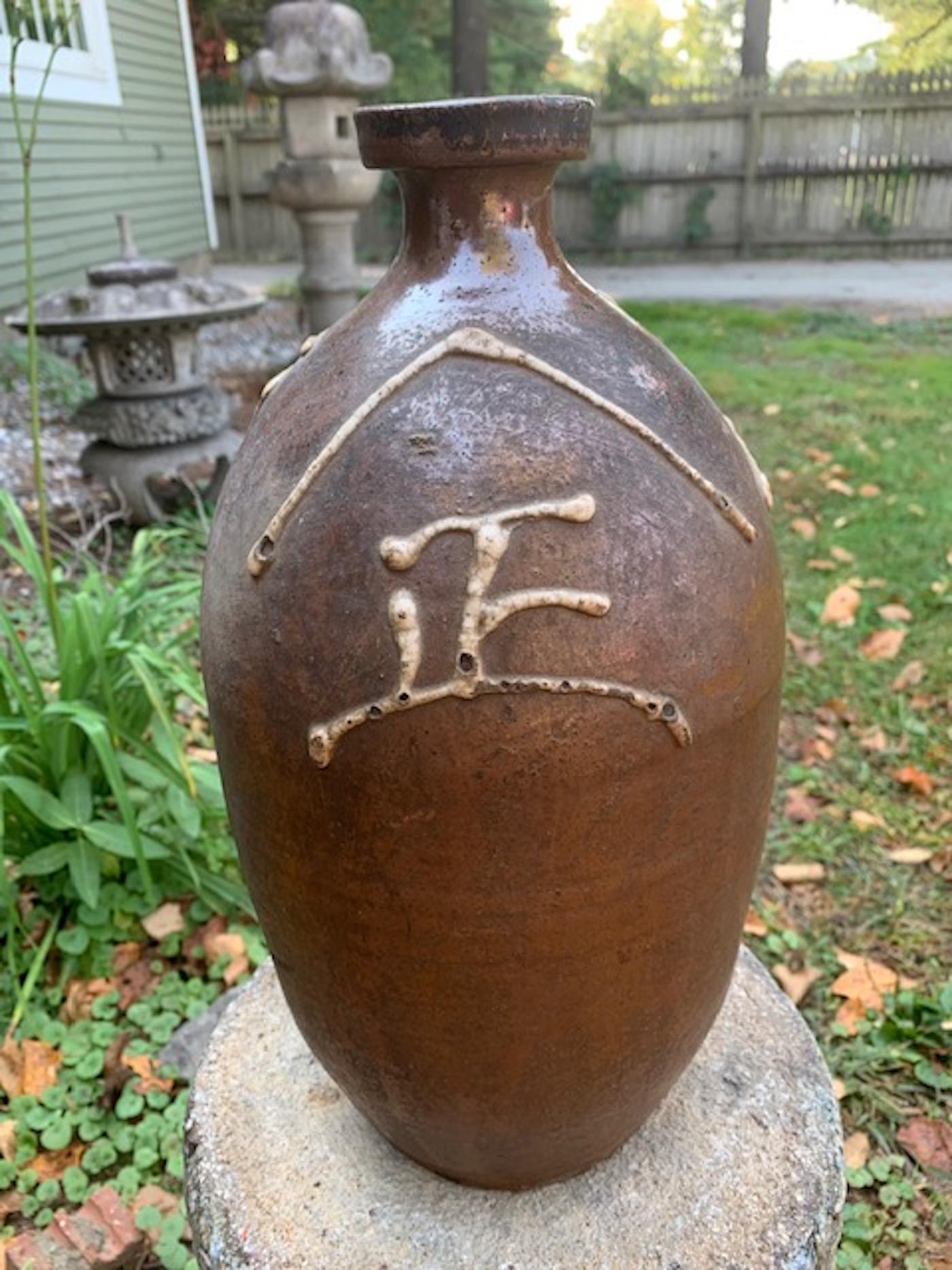 Japanese Tokkuri, (Sake or shochu bottle) with high relief glazed characters. Very special Tokkuri with high relief glazed characters indicating the shop and makers name. This tokkuri was made in the mid-late 19th century.