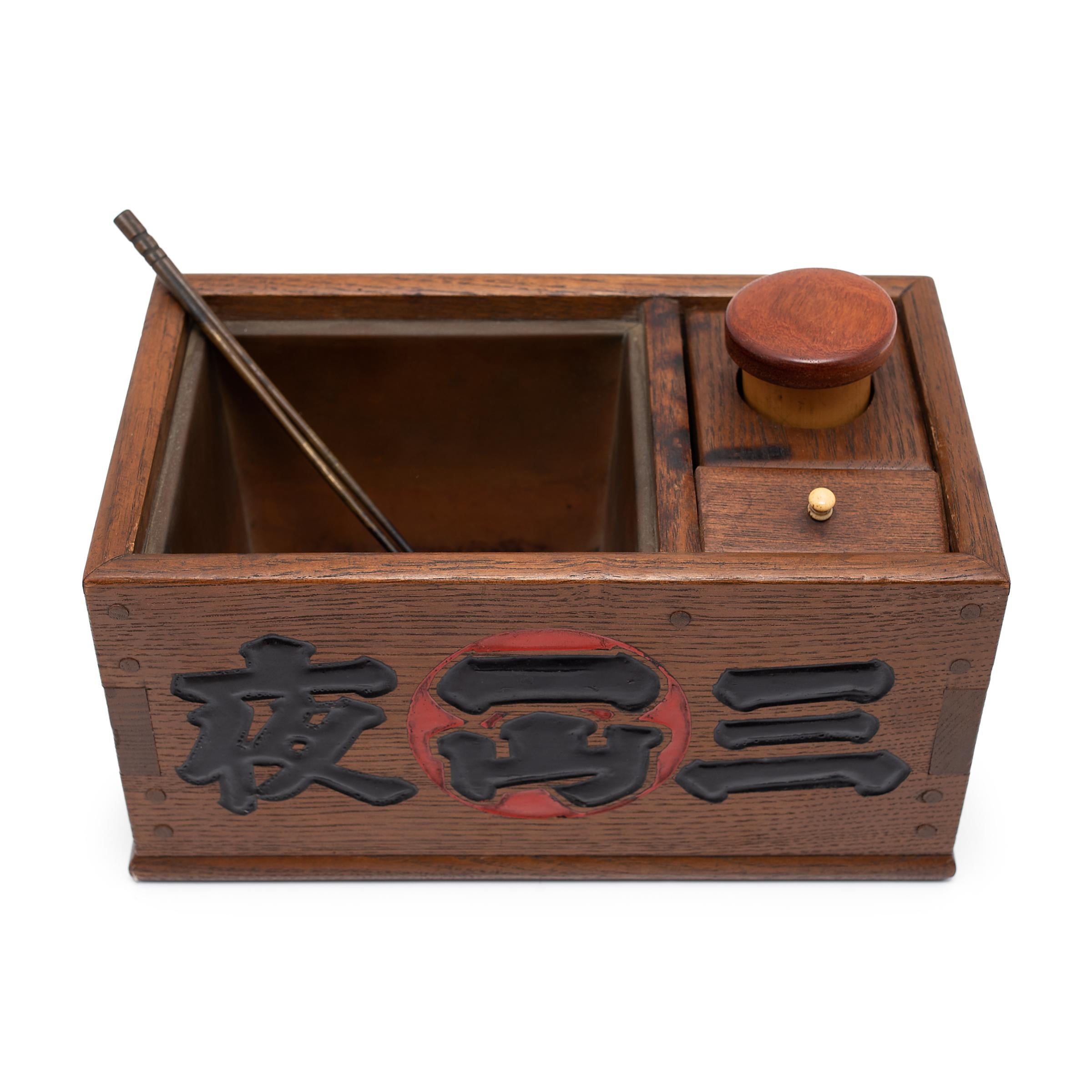 This wooden box is a Japanese tabako-bon, or 'tobacco tray,' used to store tobacco and smoking accessories. Believed to have evolved from the traditional accessories of Japanese incense ceremony, tabako-bons first came into use in the 17th century