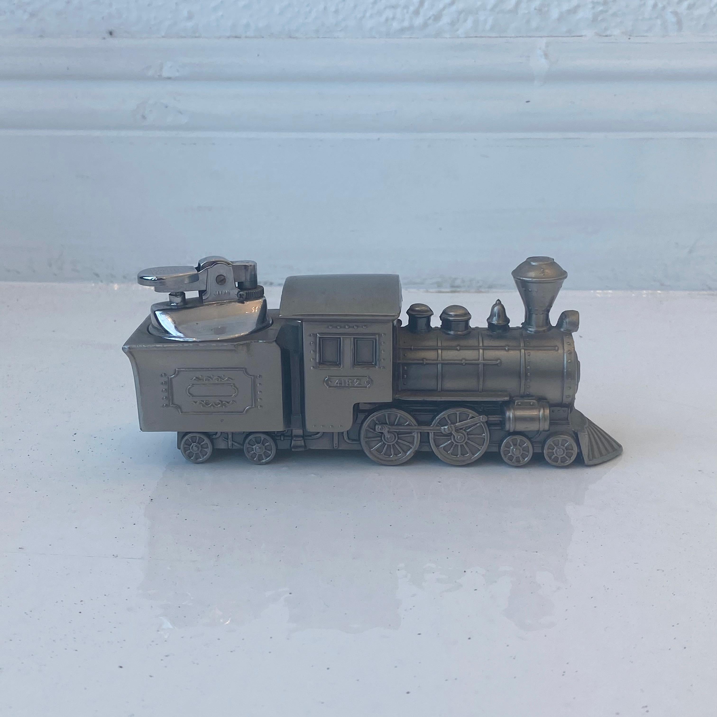 Unique vintage table lighter in the shape of a train. Made of metal with 