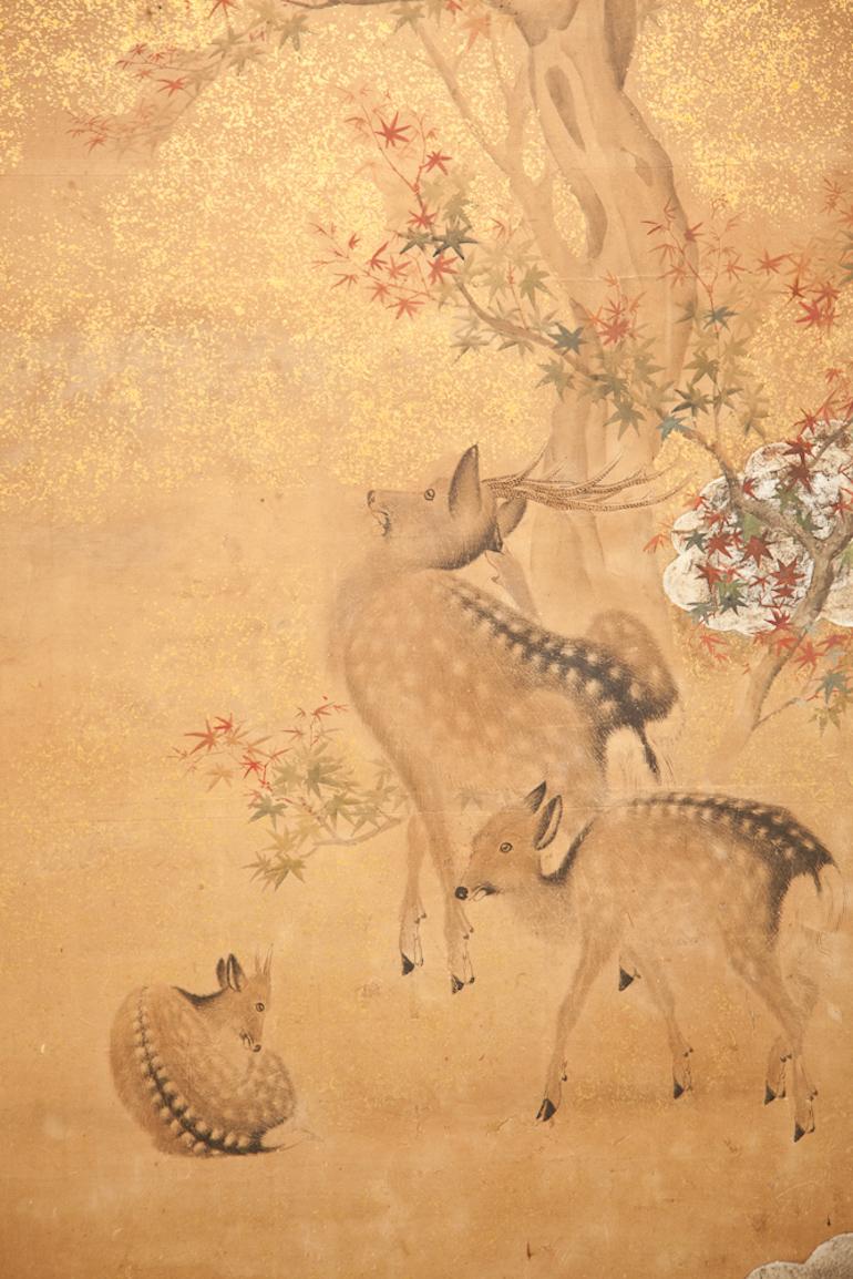 Japanese two panel screen: Nara Deer in Gentle Yoshino Landscape. Yoshino is in the Nara Prefecture, an area famous for these small and tame deer native to Japan. Meiji period (1868 - 1912), Shijo School painting of a family of deer in a forest of