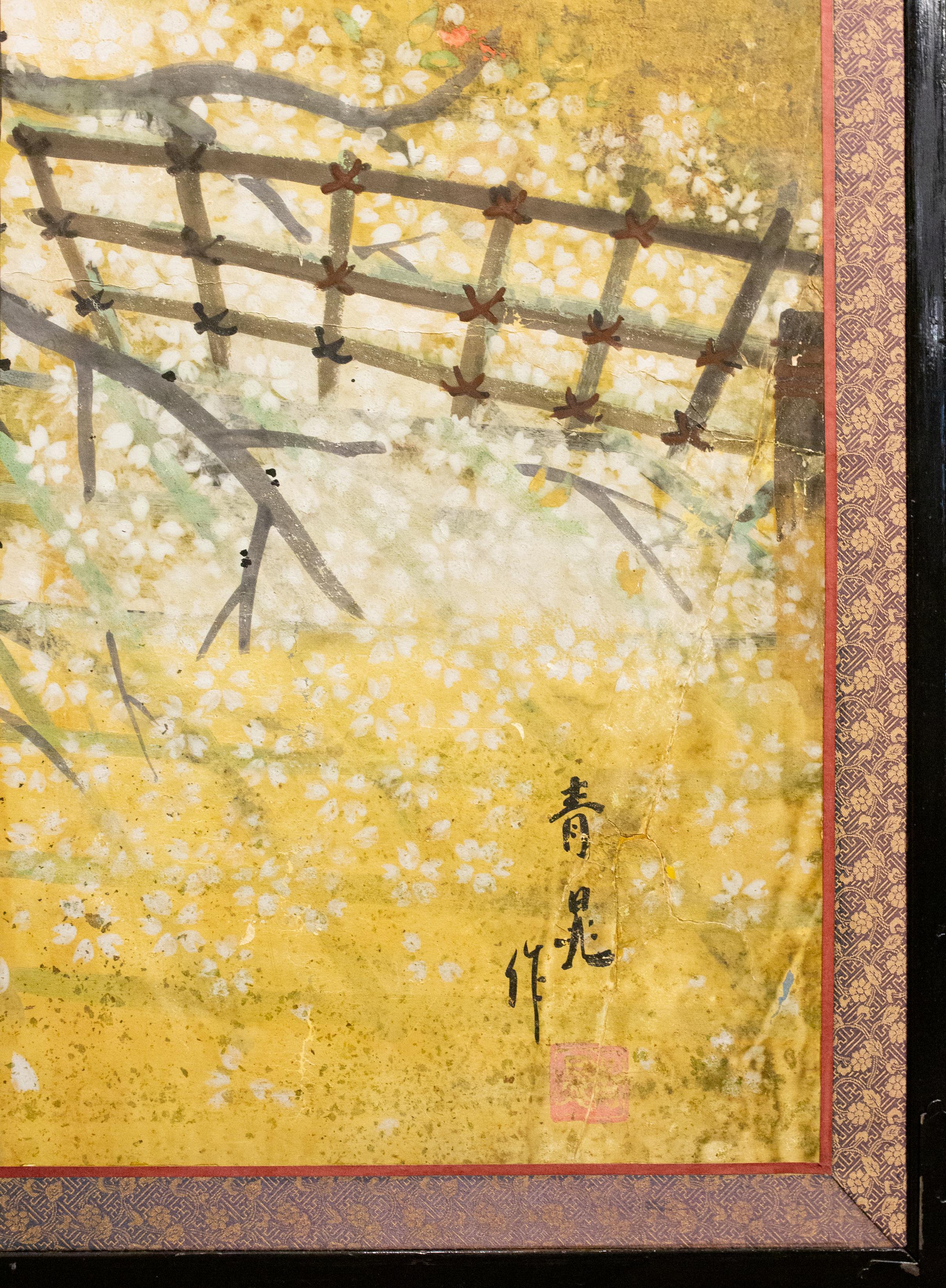 Venerable old cherry tree in bloom under crescent moon, illuminated by a campfire, with poles to support the weight of its branches. Yozakura is the ancient Japanese tradition of viewing illuminated cherry blossoms at night. Today, cherry blossoms