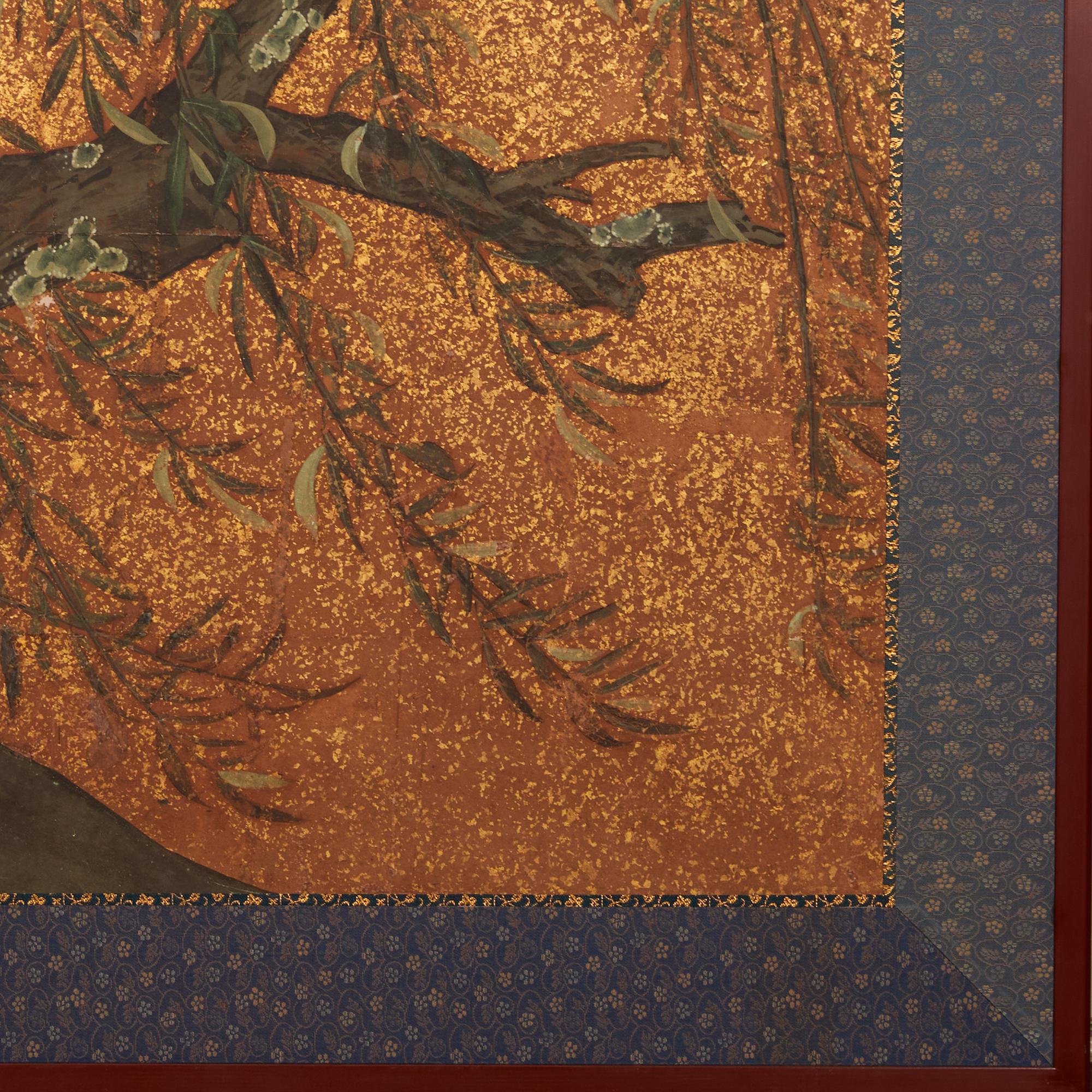 Dramatic and beautifully executed cherry blossoms trickle down the two panels with natural willows calmly coexisting with luminous gold dust fading to the ground. Mineral pigments and heavy gold dust on mulberry paper with a silk brocade border,