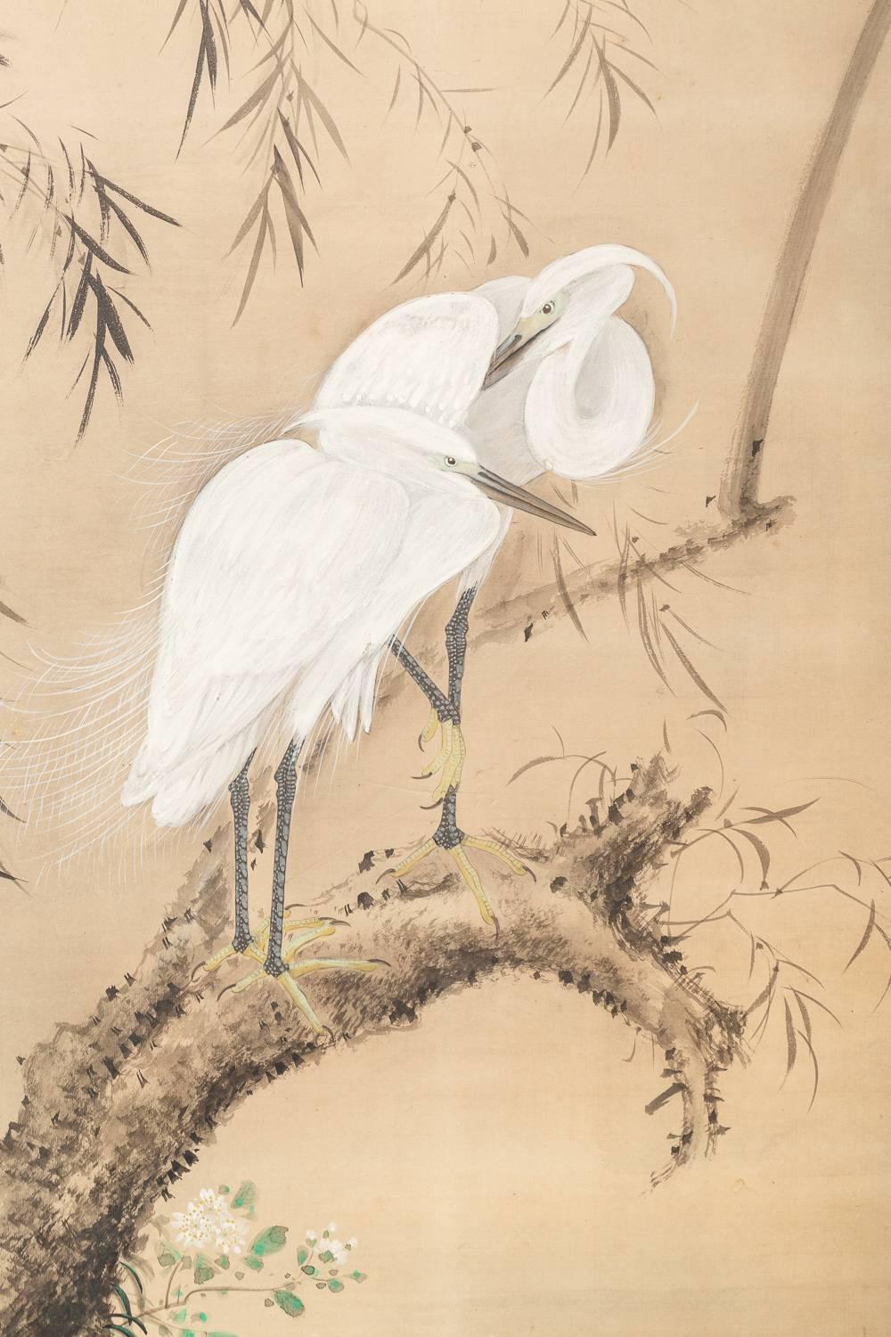 Japanese Two Panel Screen of Herons in Willow by Water Lily Pond.  Meiji period (1868 - 1912) painting of a pair of herons resting in a willow tree at pond's edge.  Painted in mineral pigments on mulberry paper.  Artist's signature and seal read: