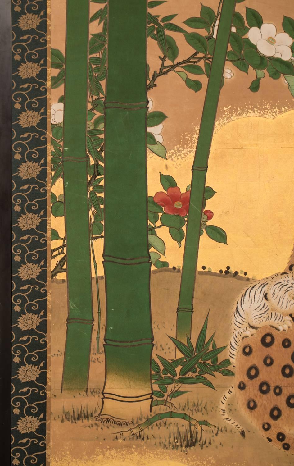 Nuages dorés sur feuille d'or avec camélia au bord de la rivière.
Dans l'histoire, les artistes japonais n'ont pas vu de léopards ou de tigres dans la vie réelle car ces animaux n'étaient pas originaires du Japon, ils vivaient en Chine. Les