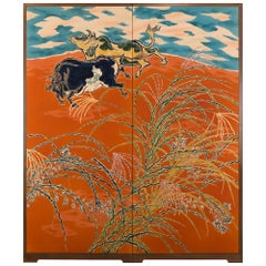 Écran japonais à deux panneaux représentant des bœufs gambadant dans un pâturage d'herbes sauvages