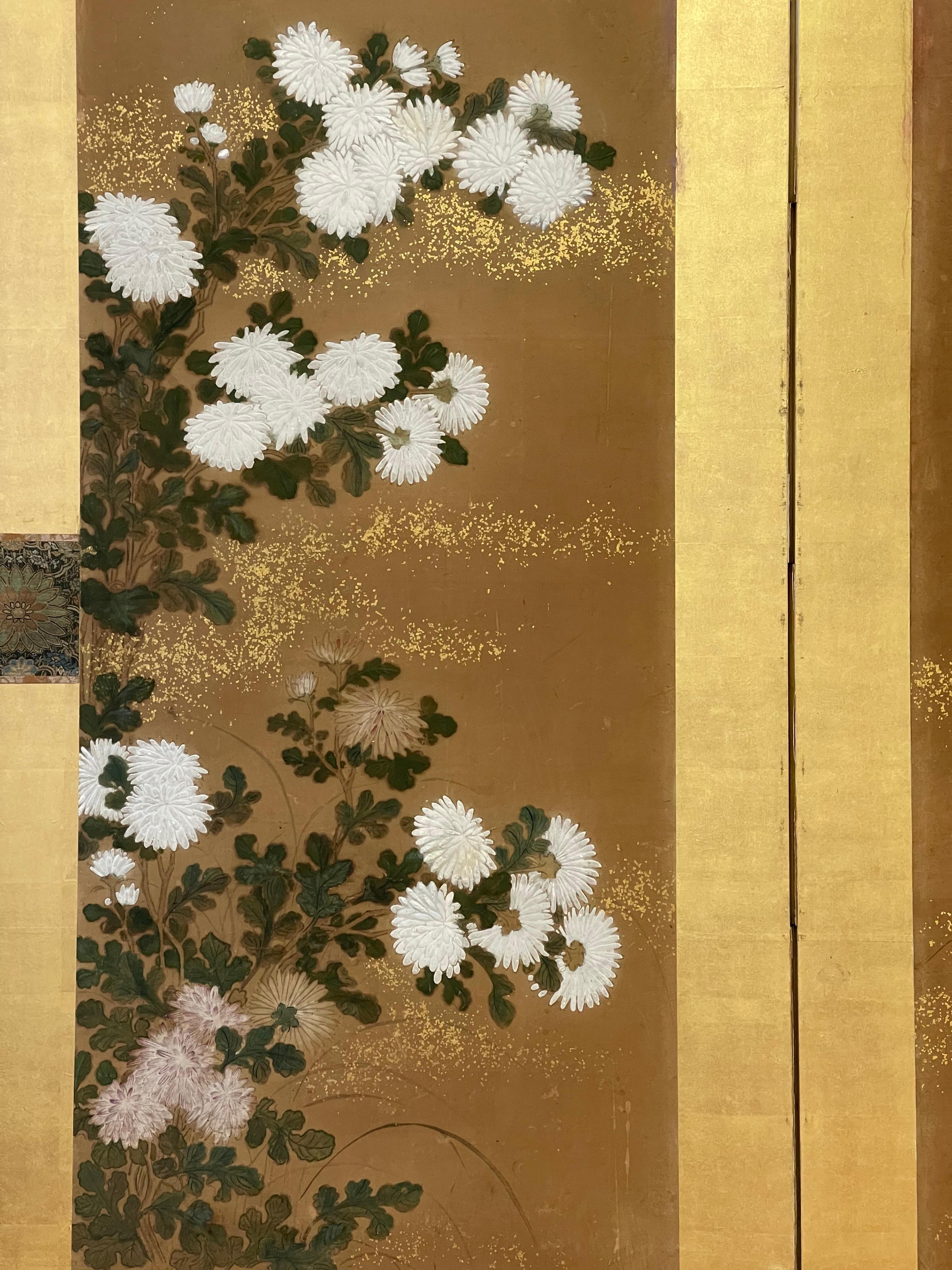 Gorgeous two panel Japanese screen featuring chrysanthemums 17th century. Featuring Oyster shell lacquer (Gofun), Mineral paint and gold dust on mulberry paper. Sumptuous brocades of silk with gold leaf frame. A masterpiece of design and composition