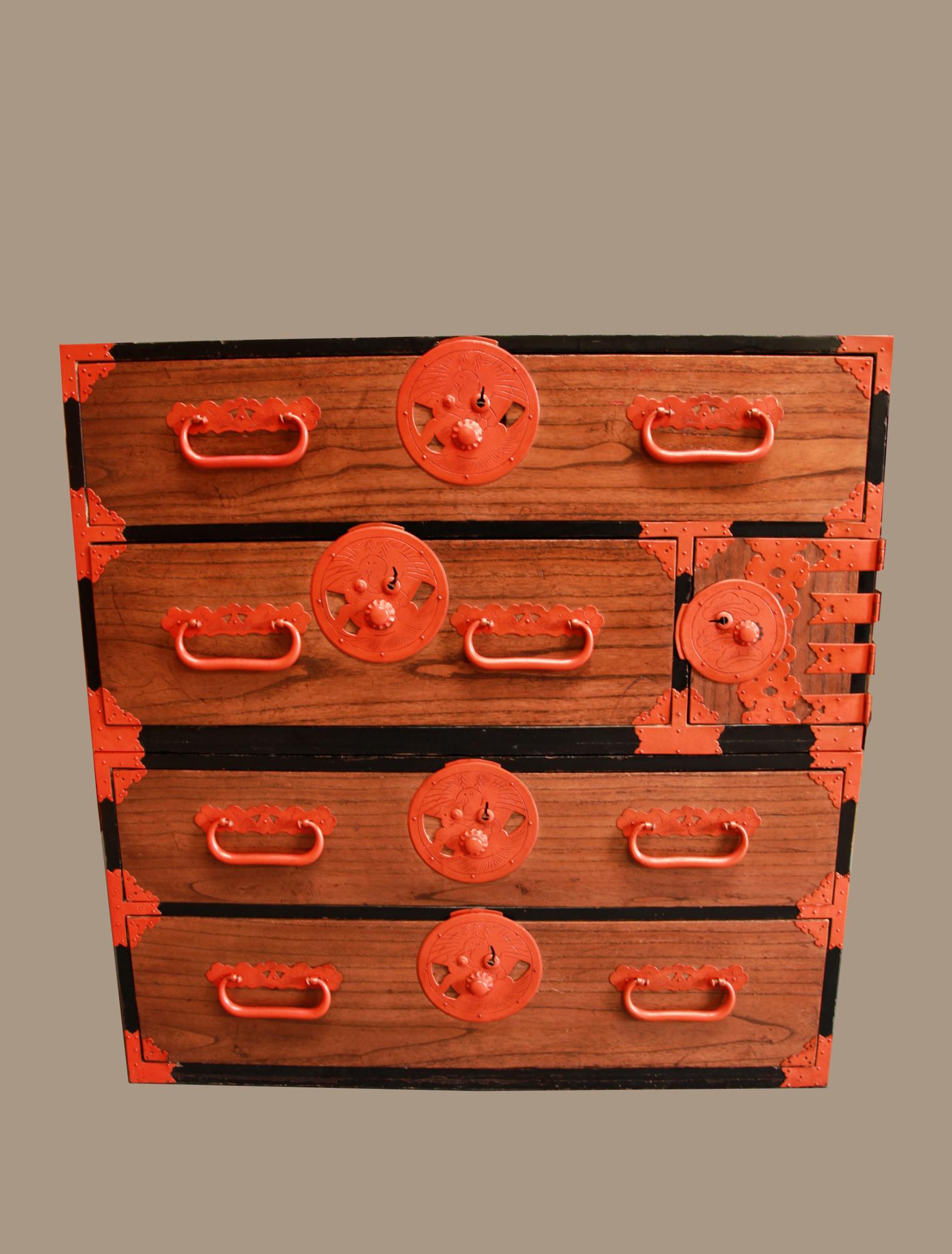 Japanese two section Tohoku Kasane Tansu, Meiji, late 19th century.

Drawers are light colored Kiri wood with hand forged metal hardware in vermillion finish. One section has a compartment with doors and two small drawers inside. Sides and back
