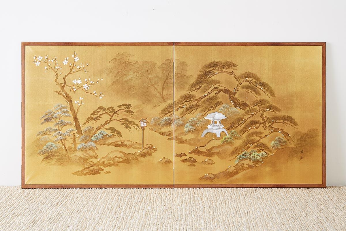 Unique Japanese two-sided folding byobu screen featuring paintings on silk depicting a garden scene on one side and three ducks with prunus on the opposite side. The front side having a gilt background and the opposite a cream silvered ground. The