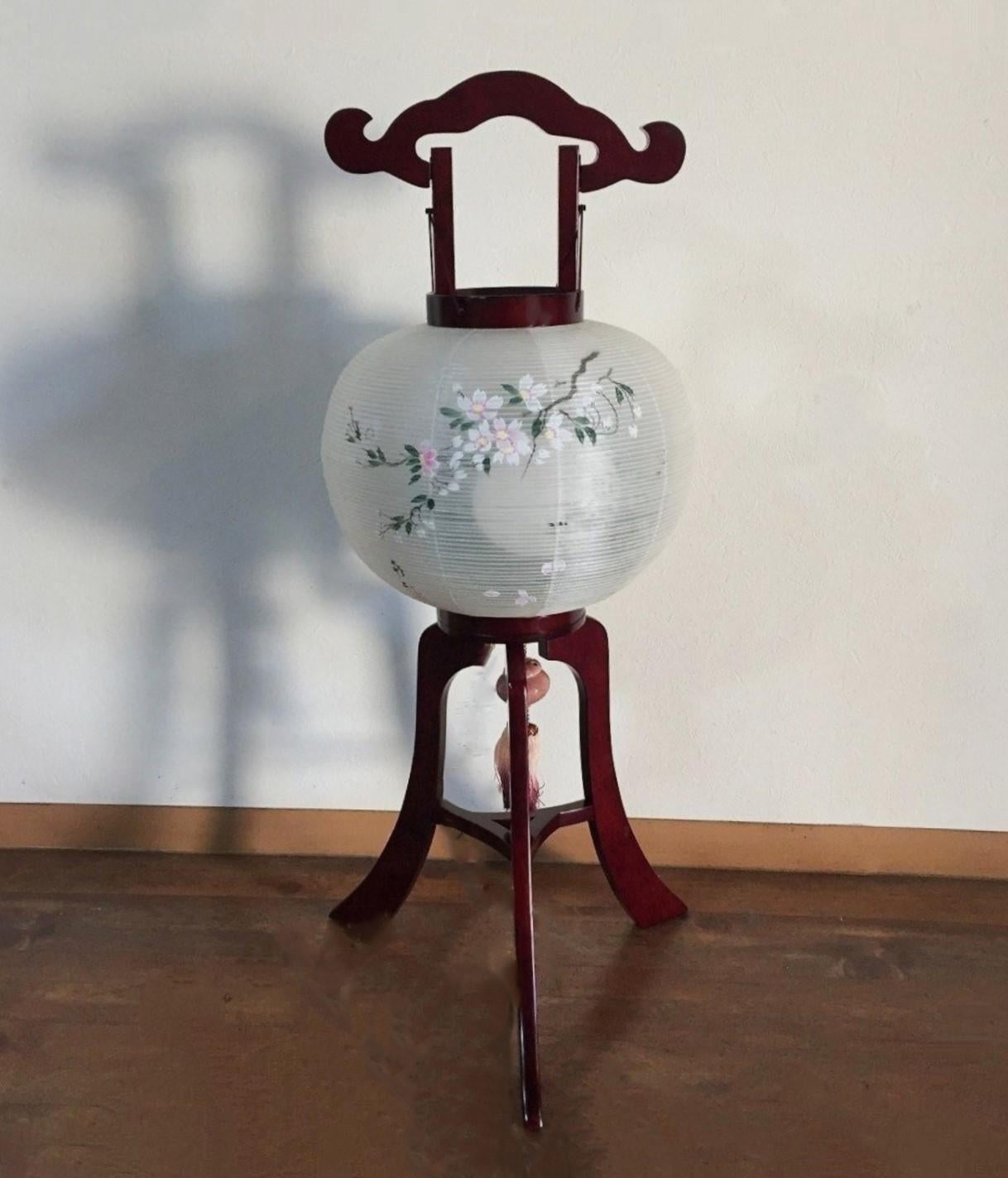 Japanese Vintage Buddhist Chochin Lantern or floor lamp by SUZUKI ANDON, Japan, 1980-1990. Lacquered wood three-legged stand with hand-painted silk shade lantern, signed by the artist: 政和 MASAKAZU. 
These Chochin lanterns are displayed in front of