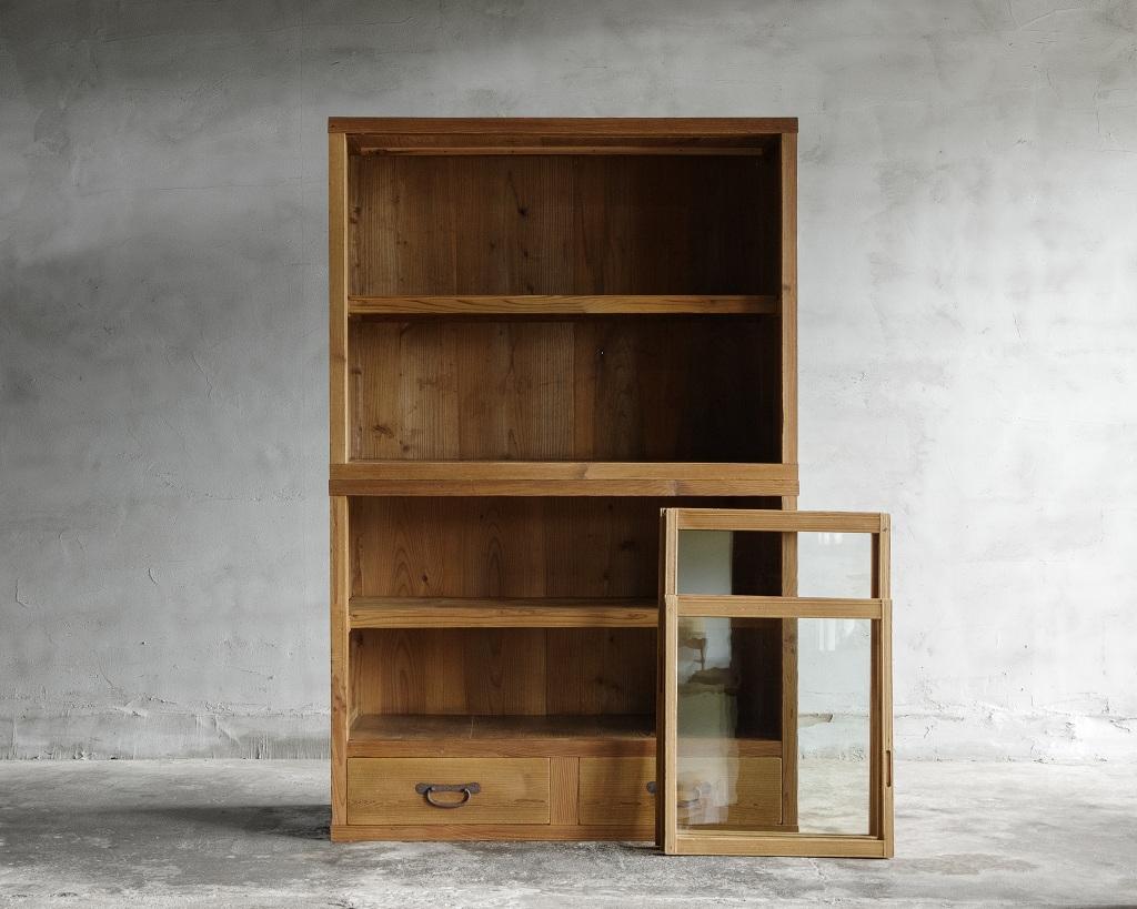 This vintage cupboard was crafted in the Early Showa Period '1926-'.

A stackable glass-front cabinet crafted from Japanese cedar wood.
Its simple, timeless design is complemented by the rustic charm of cedar, enhanced by the unique character