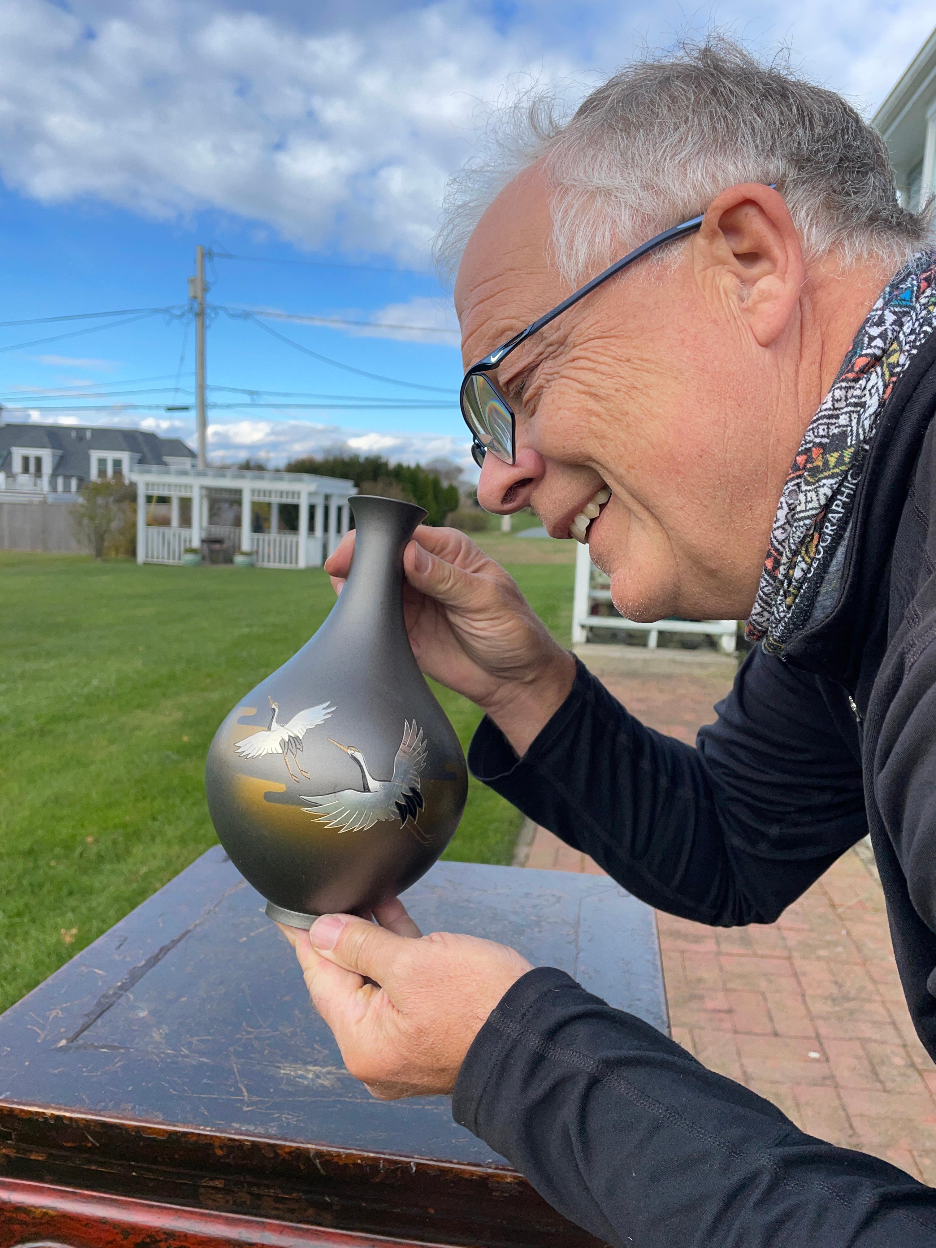 From our recent Japanese acquisitions

From Japan comes this beautiful large hand cast bronze bottle form vase in a bronze and silver finish featuring a pair of flying cranes inlaid in silver and hand painted black colors. The cranes flying among