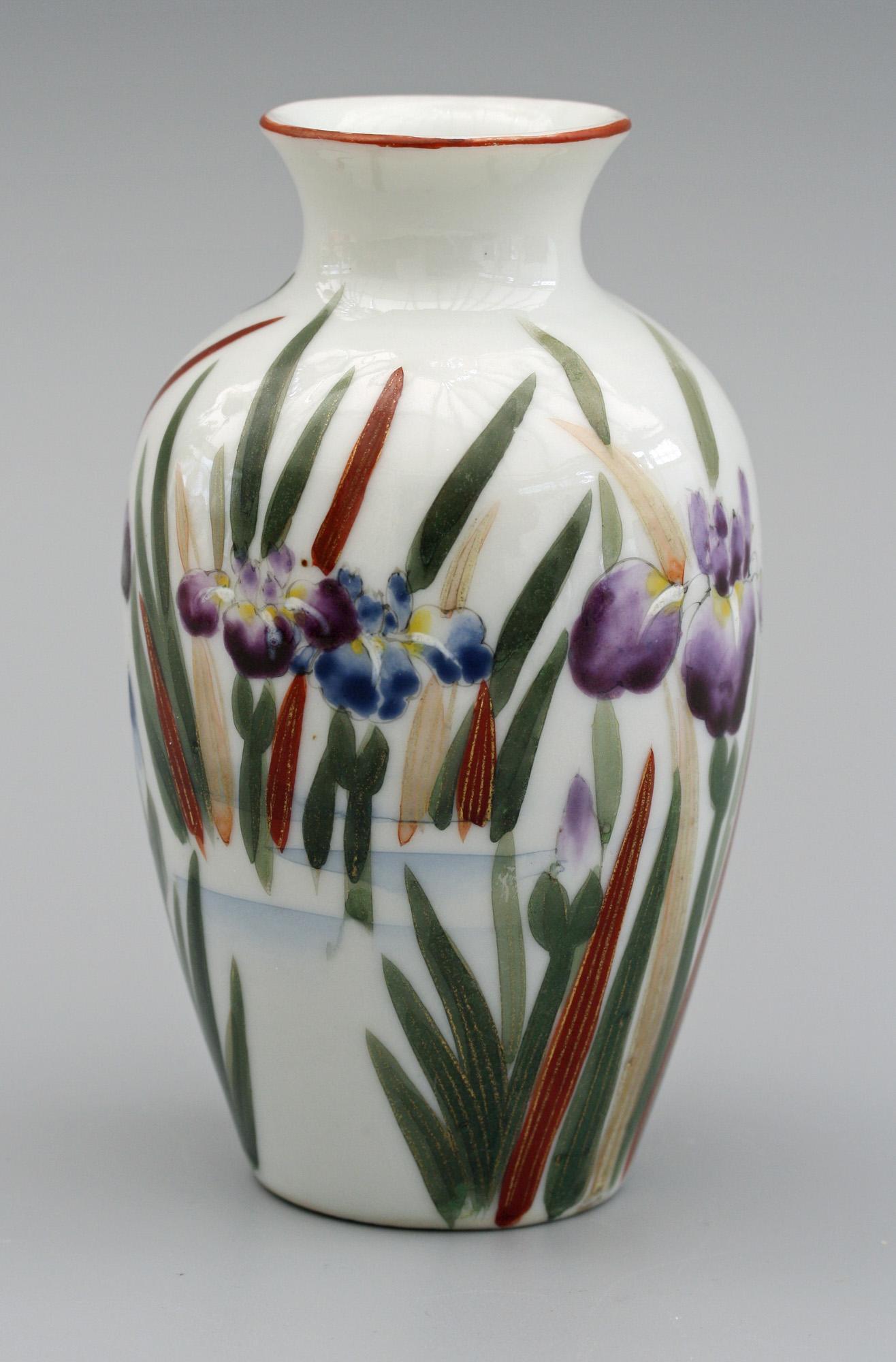 A very fine vintage Japanese porcelain vase, probably Arita Fukagawa, hand painted with a bird amidst flowering iris's dating from the first half of the 20th century. The small bulbous shaped vase has a narrow and short trumpet shaped top and is