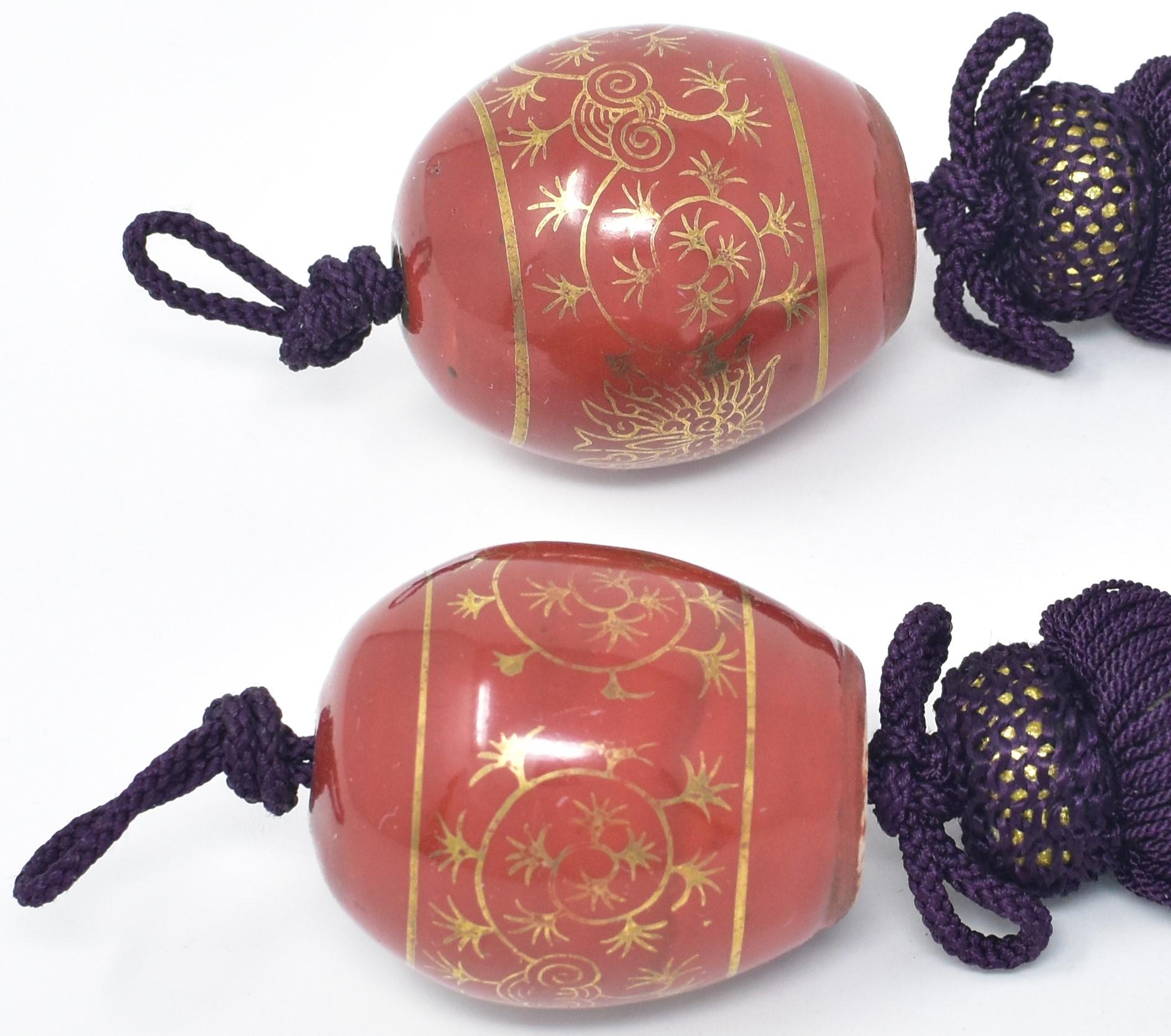 Pair of vintage porcelain scroll weights (fuchin) in orange from the Kutani region of Japan.
Dating from the prewar Showa period of circa 1960, these egg-shaped scroll weights are gilded and hand-painted. Each piece bears the mark of Kutani on the