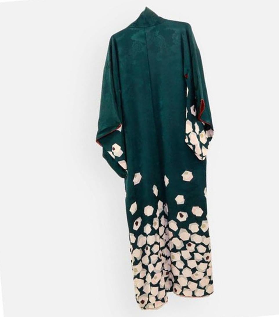 A Striking Japanese formal Silk Woman's Kimono (or Tomesode). The Kimono is hand sewn, elegantly resist-dyed along the lower body with stylized cream colored pentagon designs on dark green, fabulous red interior lining, creating a stunning contrast.