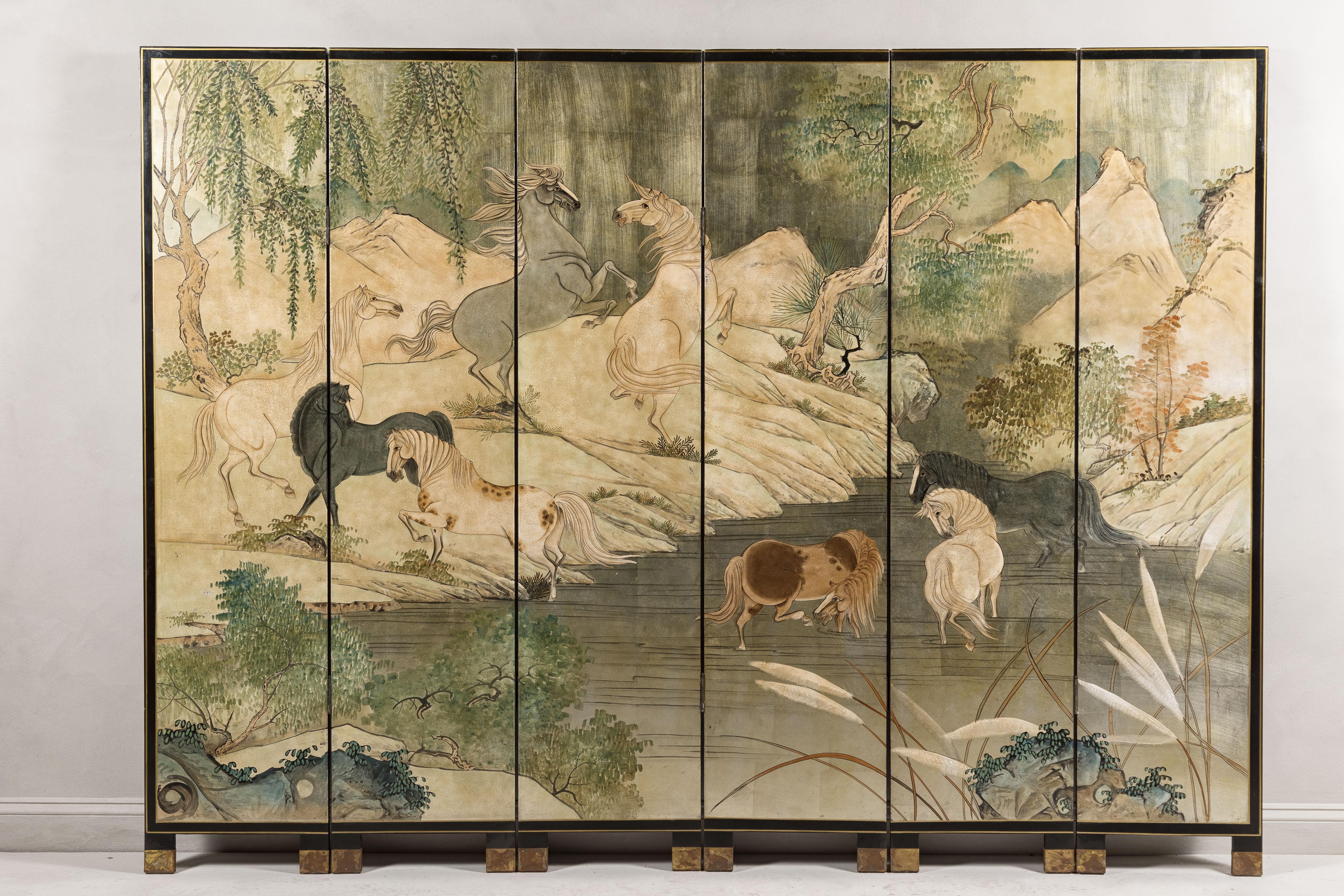 A Japanese vintage six-panel folding gilded screen with landscape and mythical horses. This vintage Japanese six-panel folding screen is a magnificent representation of gilded artistry, showcasing a vivid landscape bustling with mythical horses. The