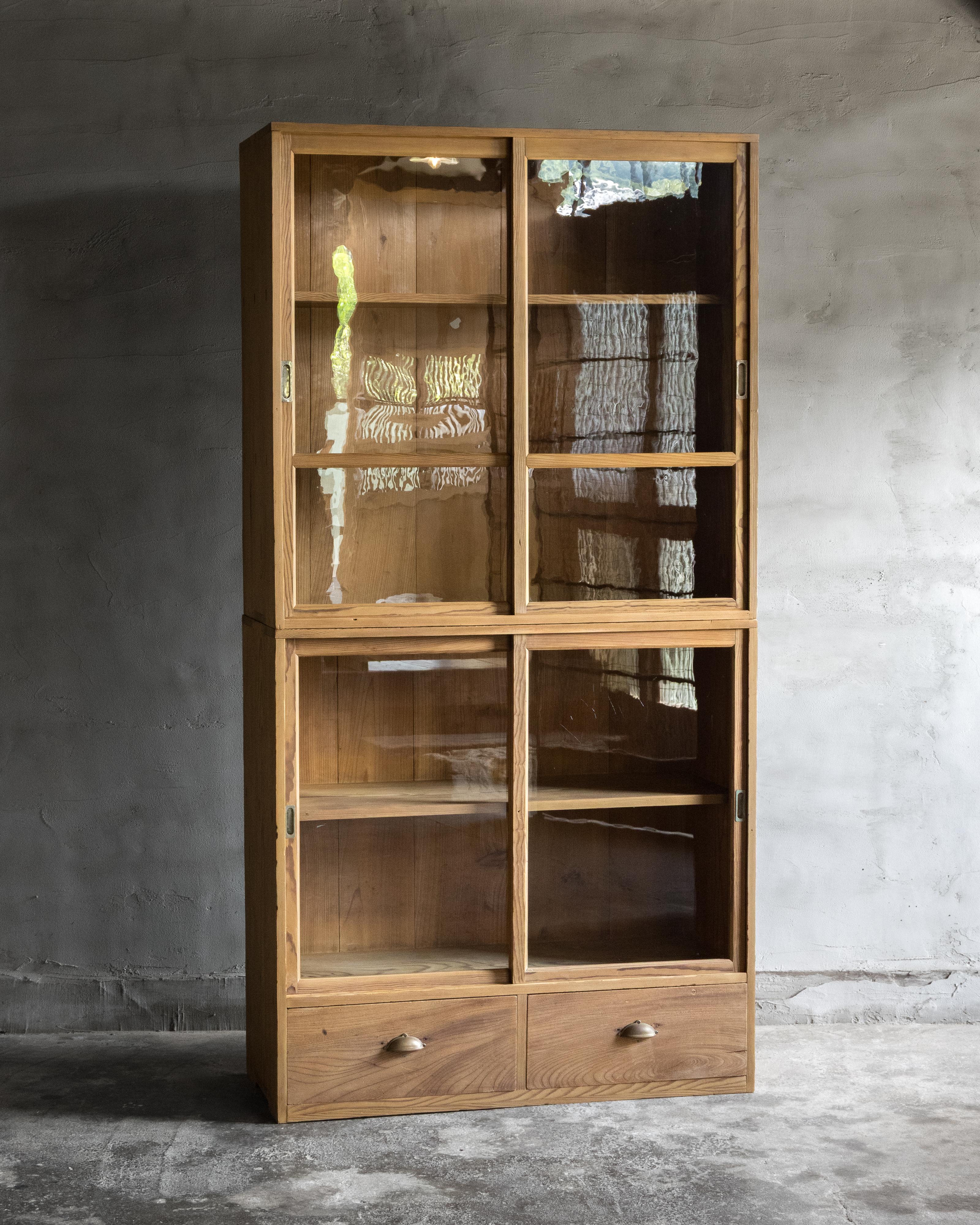 Questa vetrinetta vintage giapponese impilabile è stata realizzata nel primo periodo Showa (1926-).

Costruita in legno di pino giapponese (matsu), ha una presenza tranquilla e bella, dal tono leggero, con una patina delicata e ammorbidita dal