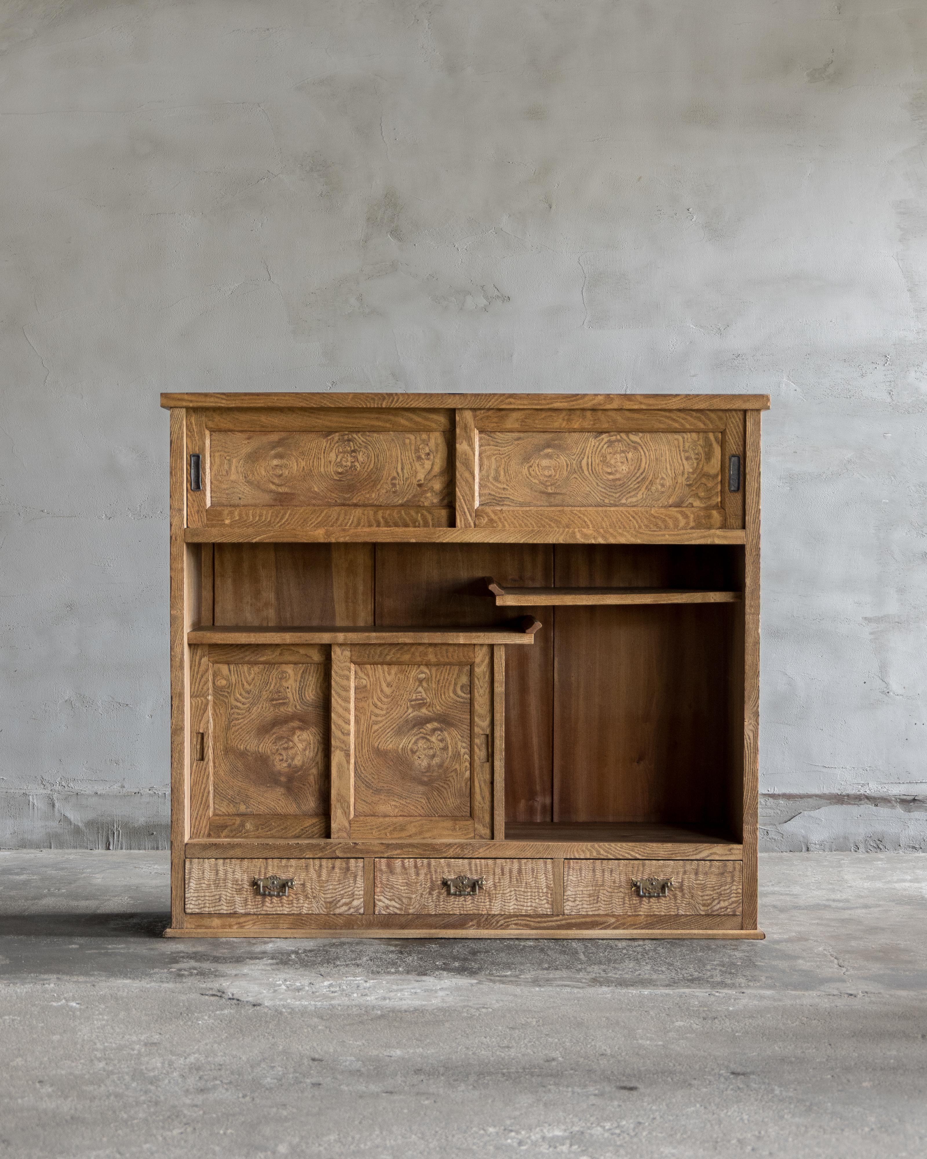 This vintage tea cabinet was crafted in the Early Showa Period '1926-'.

Also known in Japan as a chadansu, the case is katsura, while the front is Japanese ash (tamo) with a gentle wave figure—a sought-after, relatively uncommon grain prized in
