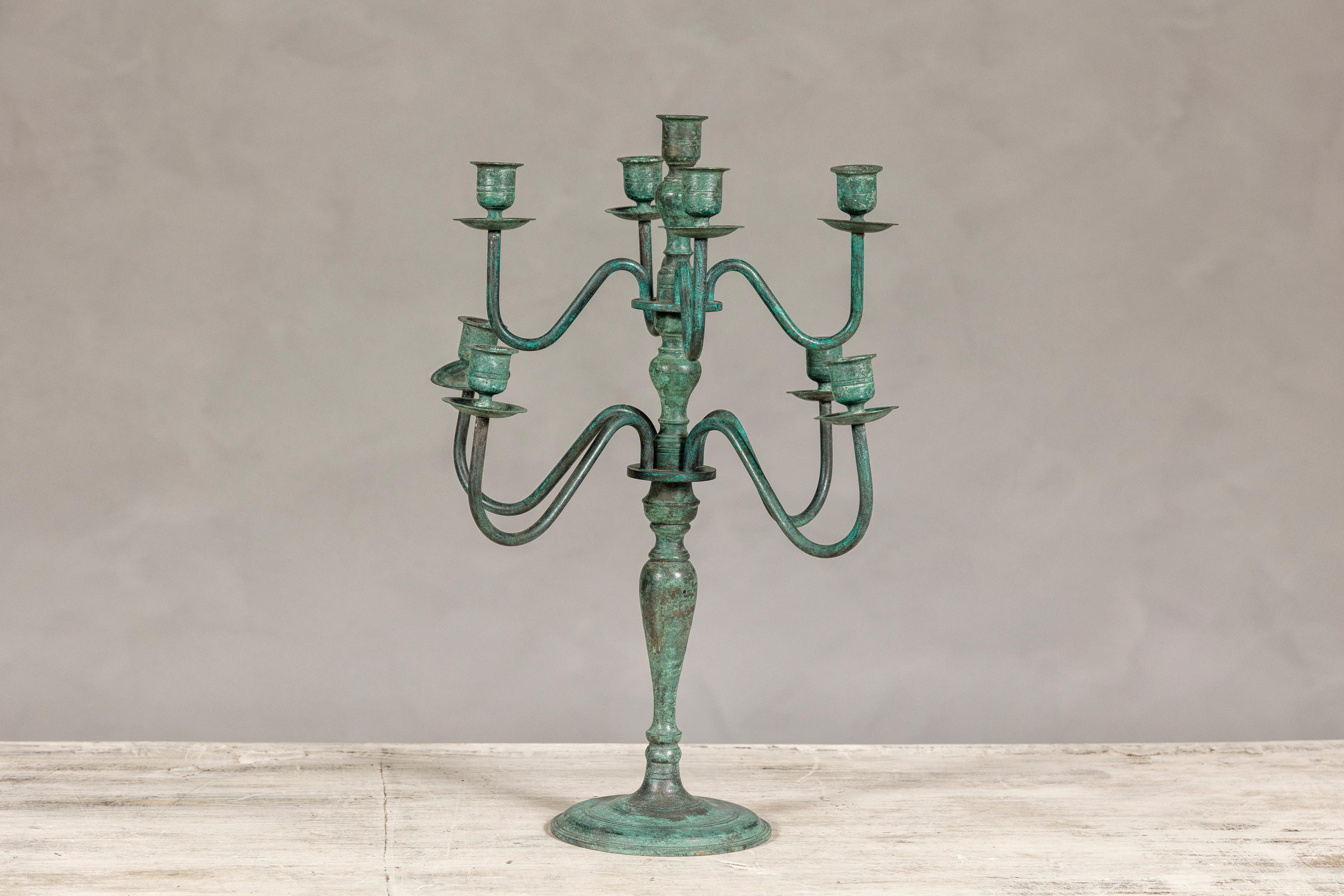 A vintage Japanese two-tiered candelabra with eight arms and verdigris patina. Immerse yourself in the serene elegance of Japanese design with this vintage two-tiered candelabra, a piece that marries the aesthetics of Japan with the timeless beauty