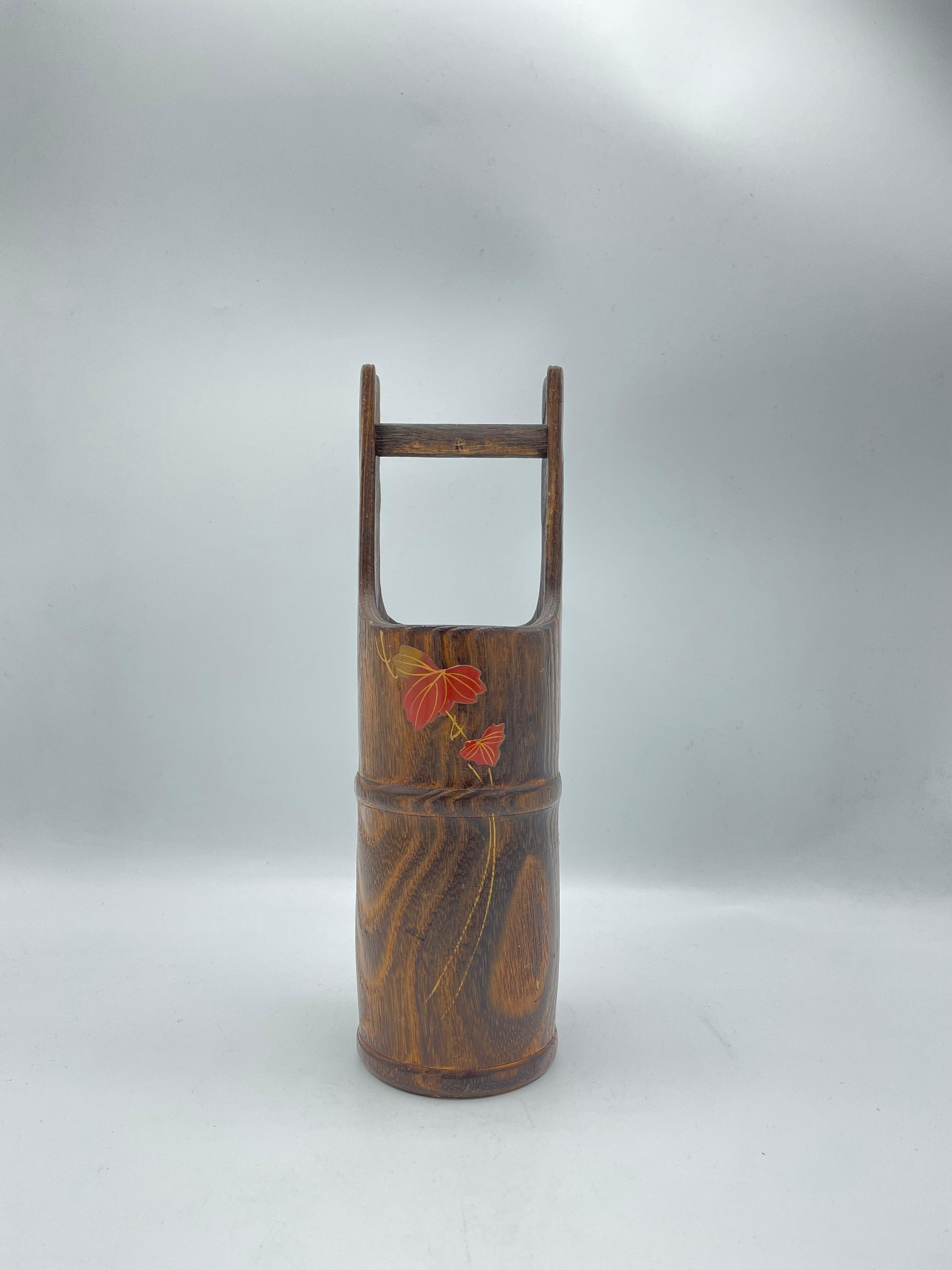 This is a flower vase which was made in Japan around 1970s in Showa era.
It is made with a wood and inside, there is a metal to put some water.
It can use as a flower vase and also as a decoration.
There are a motif of leaf of Mable. 

Dimensions:
7